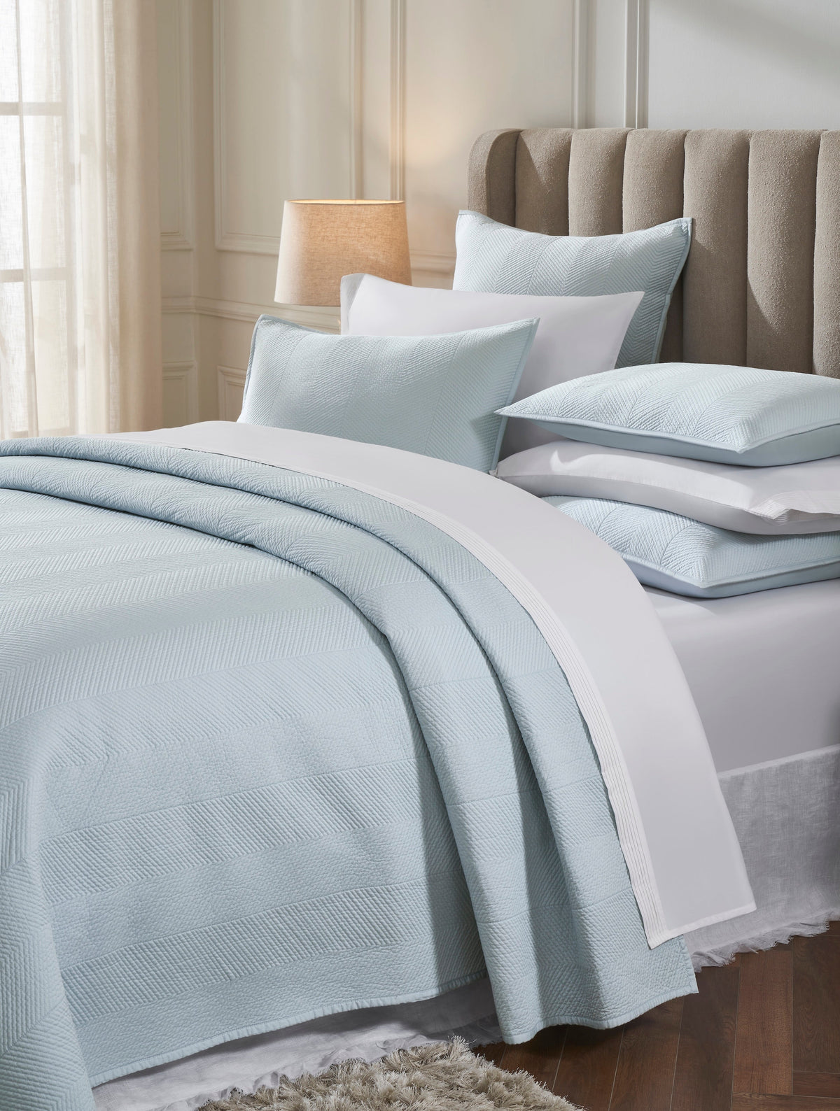 CL-262-11096_3|Detailed view of a light blue quilted coverlet set, showcasing its stylish herringbone pattern and soft texture on a bed.