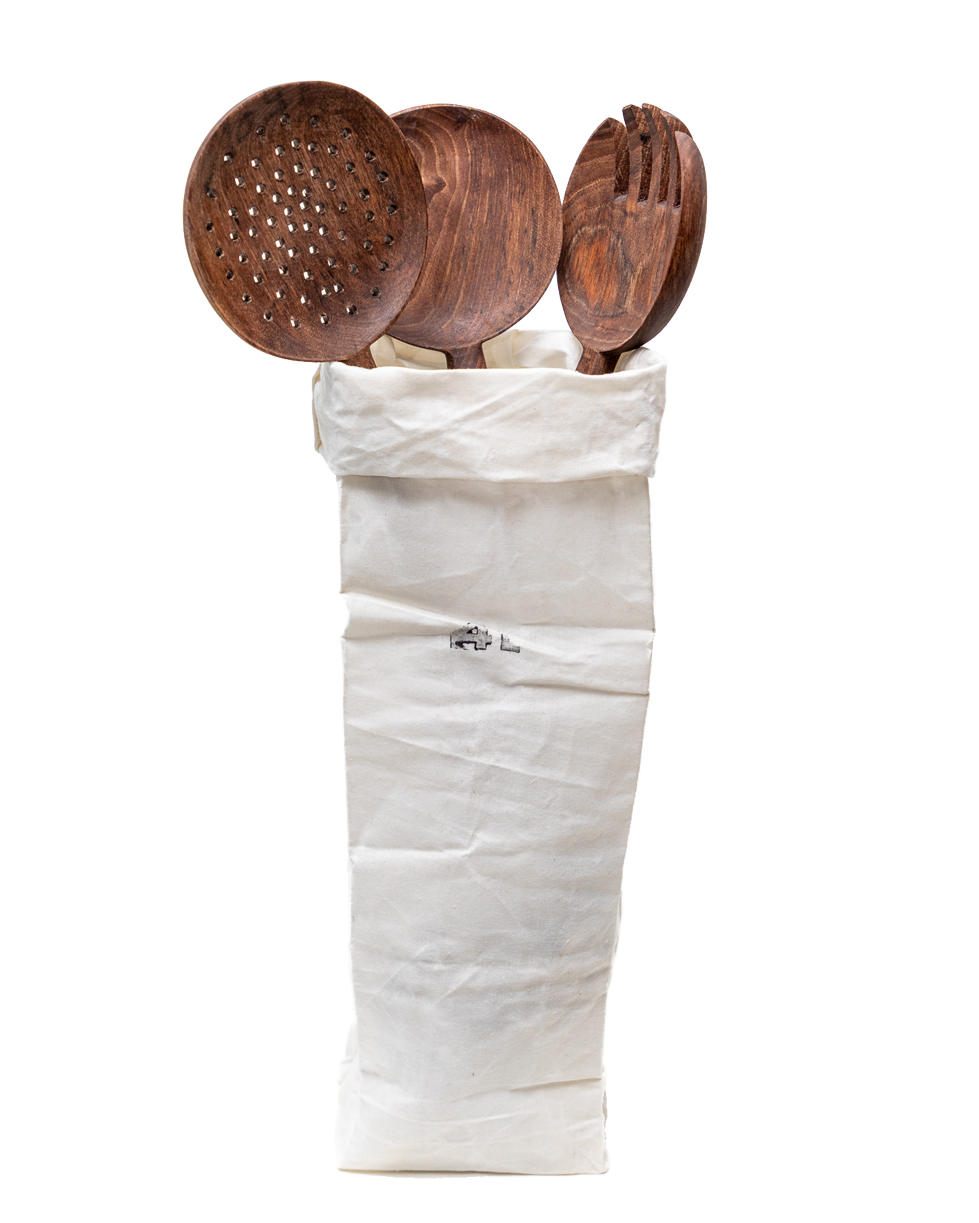 Set of wooden kitchen utensils in a white waxed cotton bag on a white background
