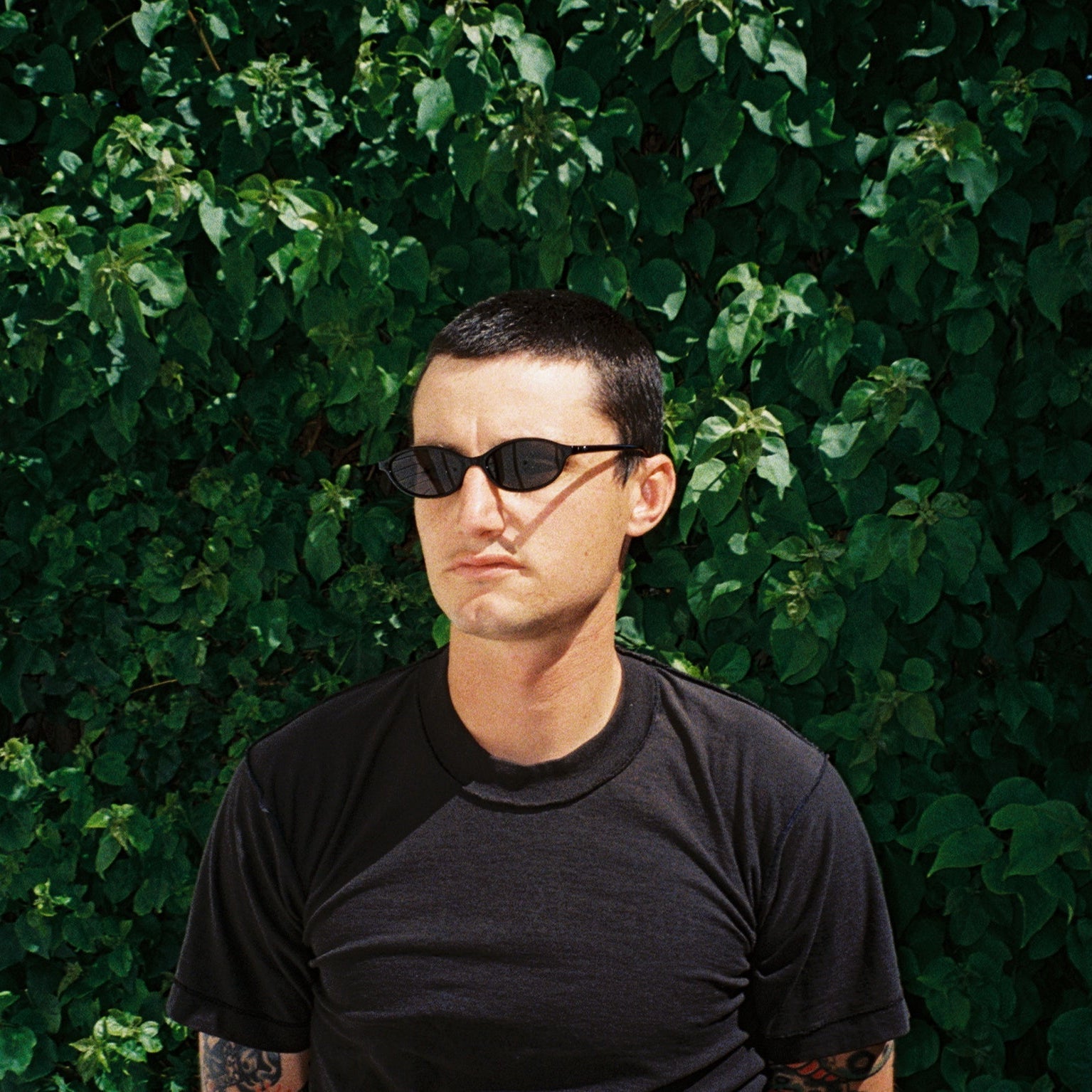 Zachary Kovacs wearing SAD Eyewear Celeste oval sunglasses in black with polarized grey UV protection lenses