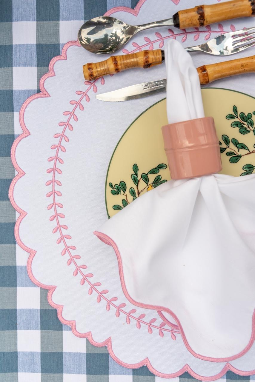 Arrow impermeable placemat with geometric border design in pink by Talah Home