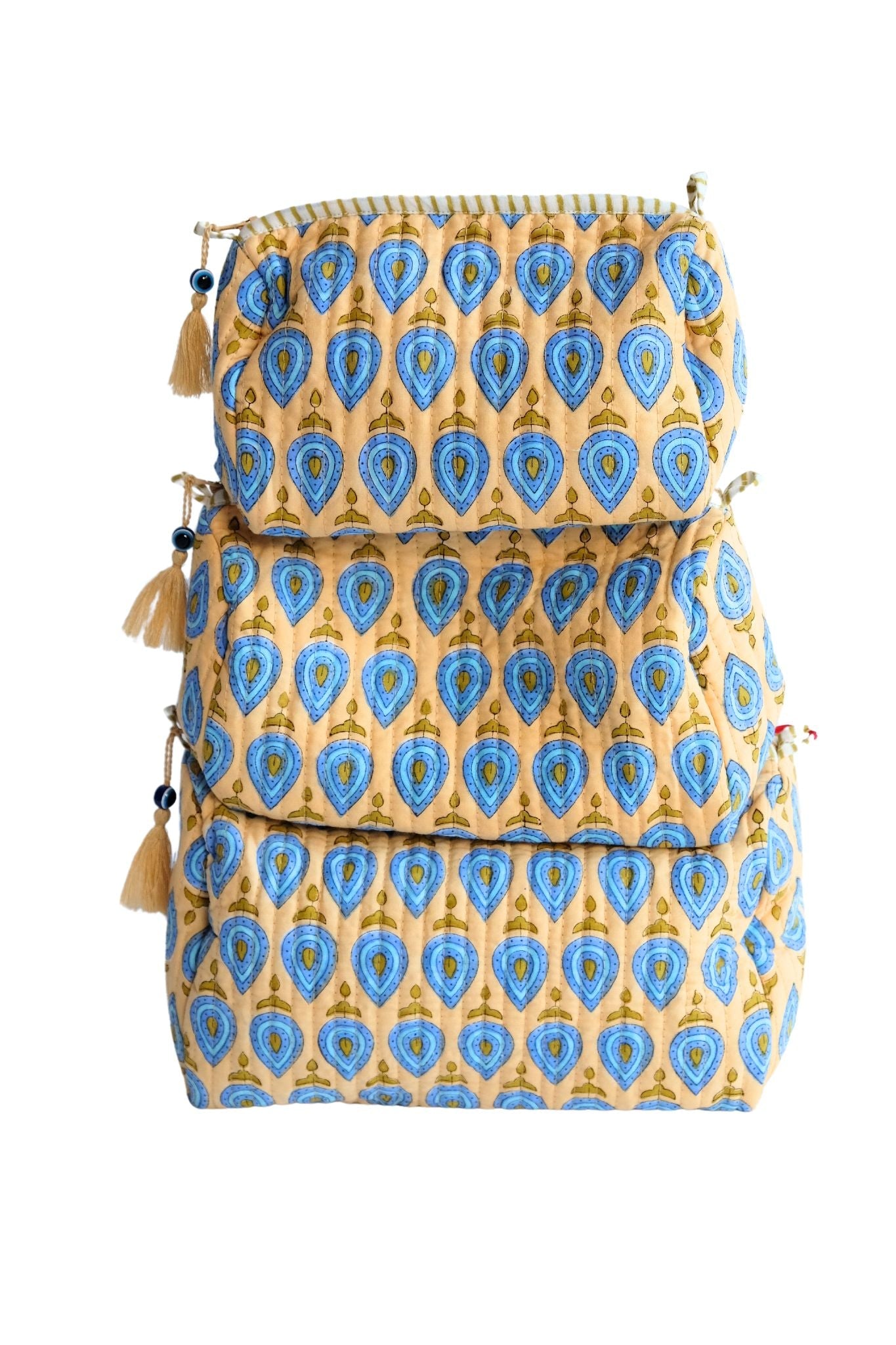 Stacked evil eye charm toiletry bags with blue teardrop patterns, tassels, zipper detail