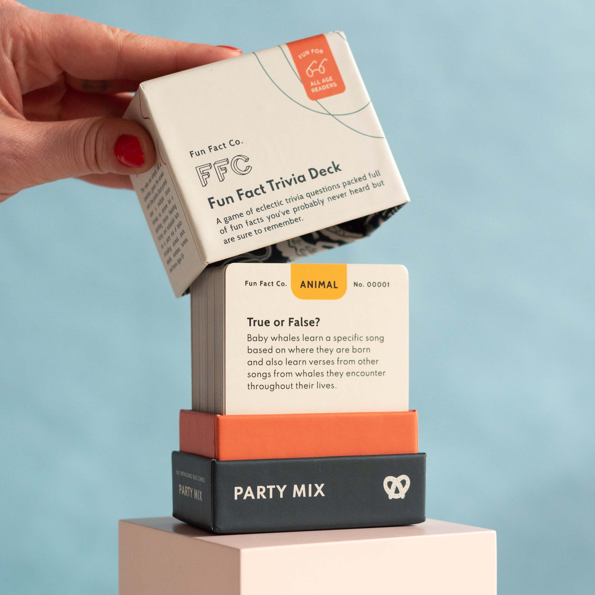 Hand holding a card over a 'Party Mix' box with a blue background