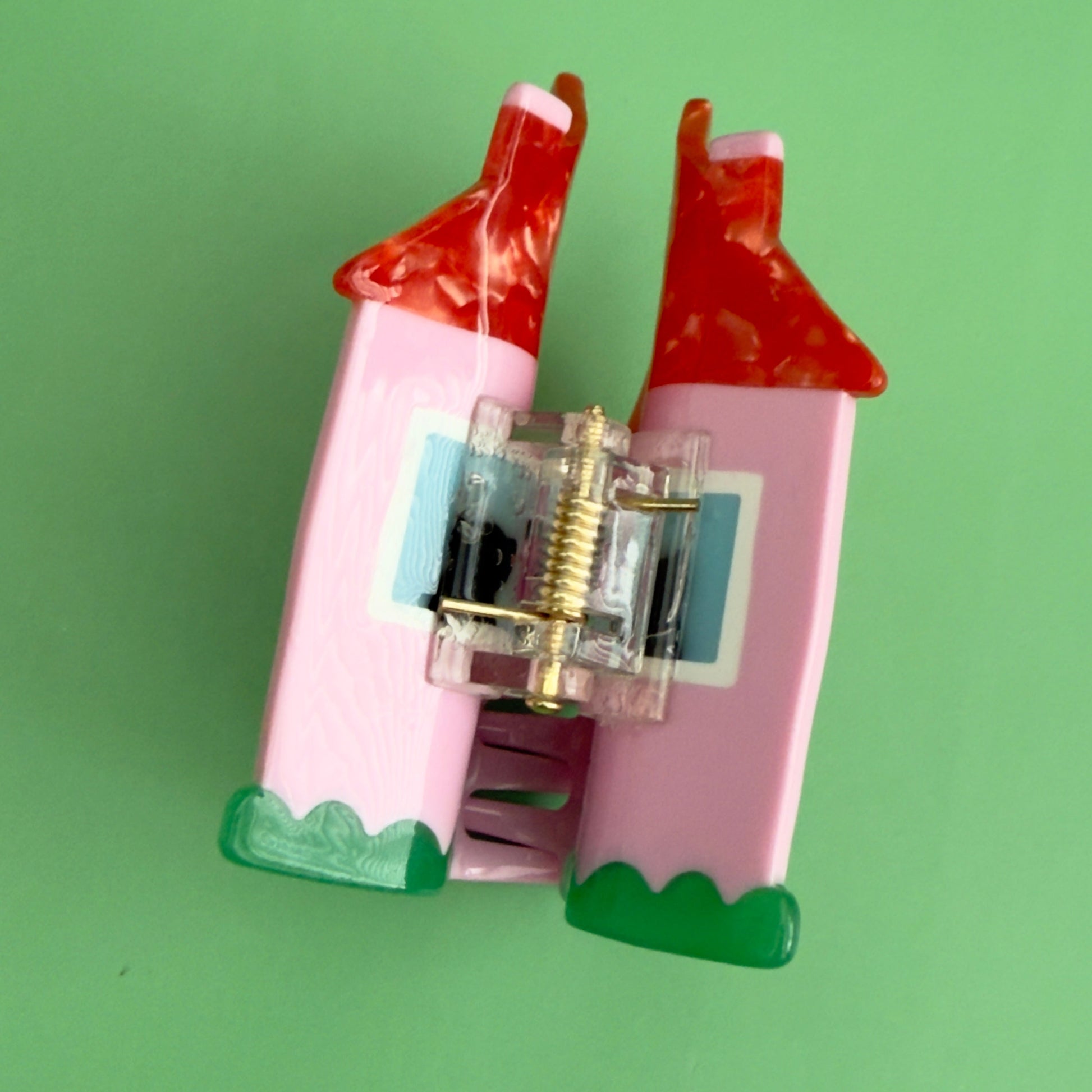 This charmin house hair claw, comes with an extra purr-k: a resident feline who will charmingly oversee the neighborhood from their sun-drenched window perch.

This practical yet cozy house hair claw, will hold strong as it's pink foundation. 

Who says you can afford a house! hehe, now you can! 