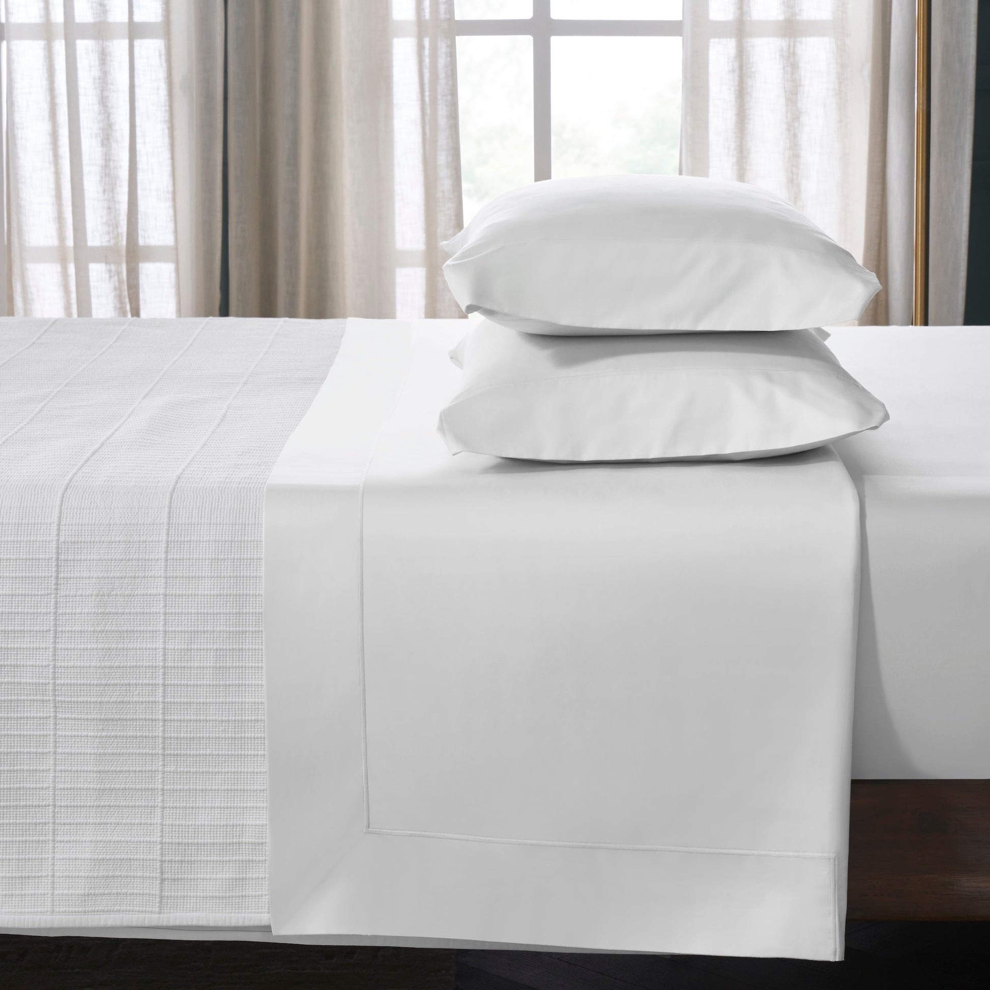 ASP-546-2032_3|White 100% cotton sateen sheet set on a bed; includes a flat sheet with a decorative hem and two matching pillowcases.