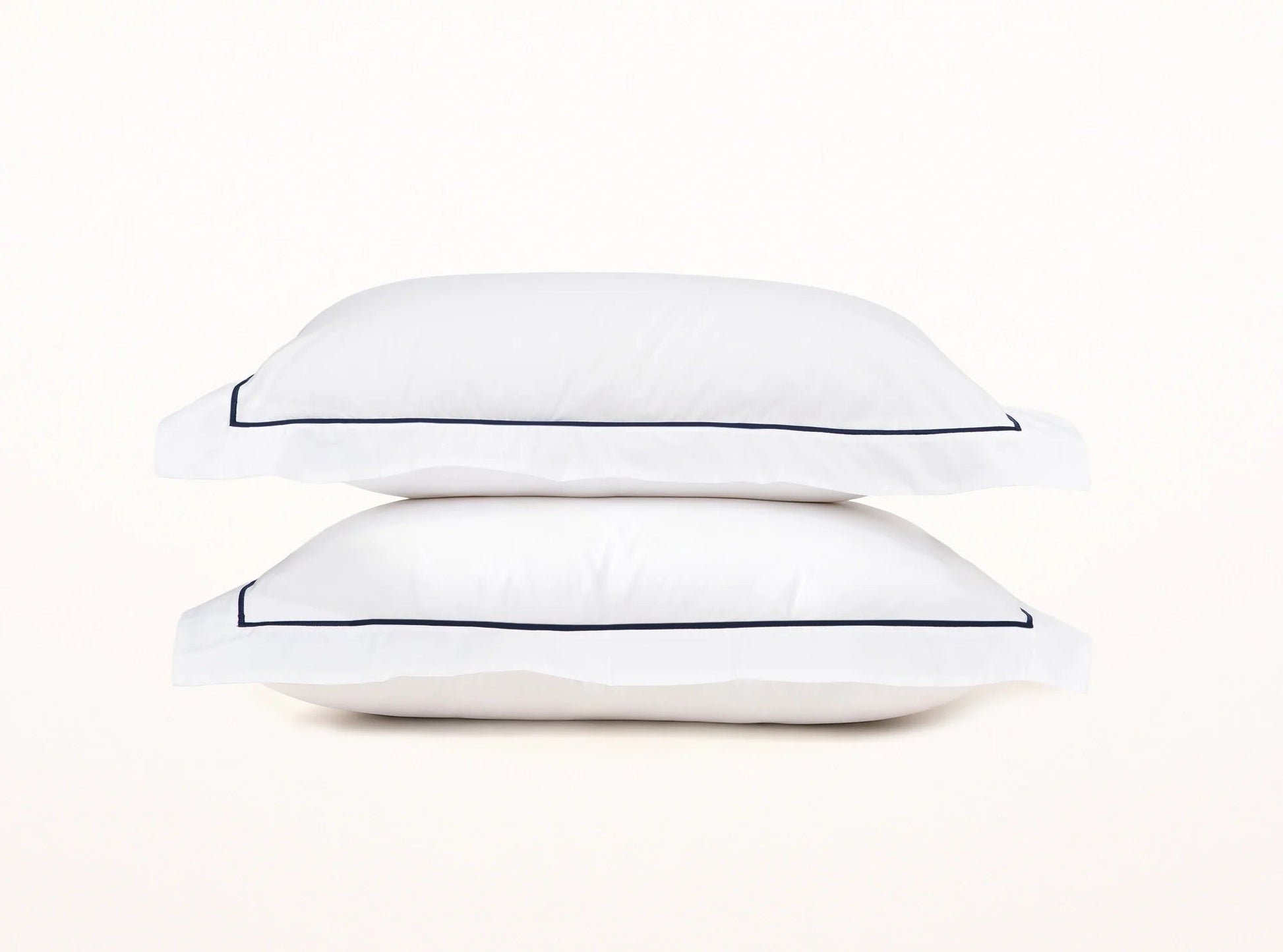 White organic percale duvet cover shams with navy blue embroidered detail - elegant contrast