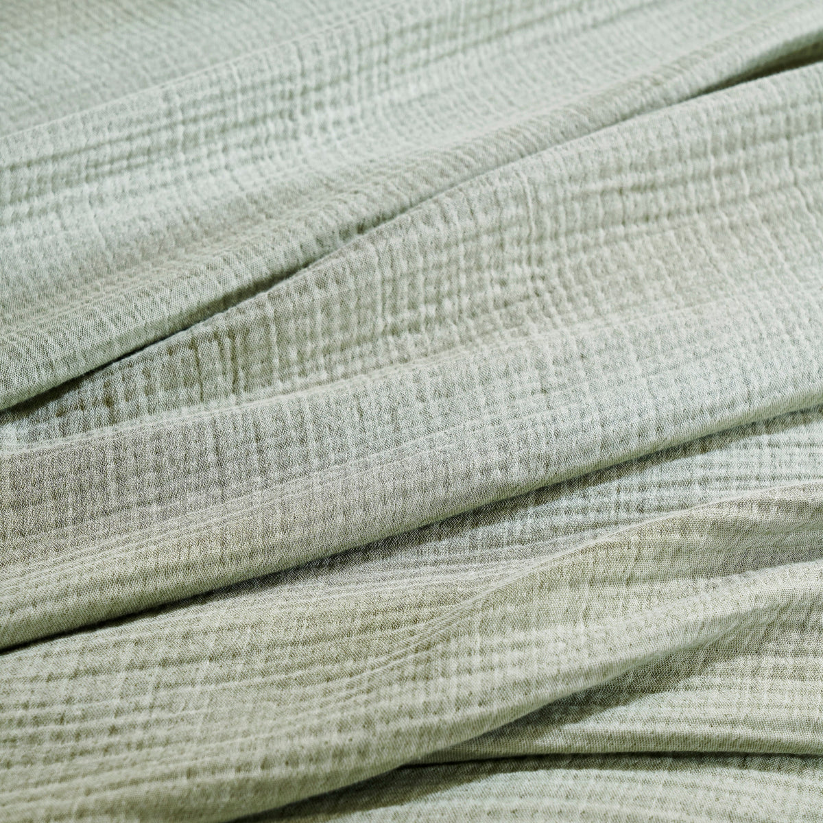 BL-864-11096_5|Close-up of the soft sage green textured blanket fabric, highlighting its breathable and cozy woven material.