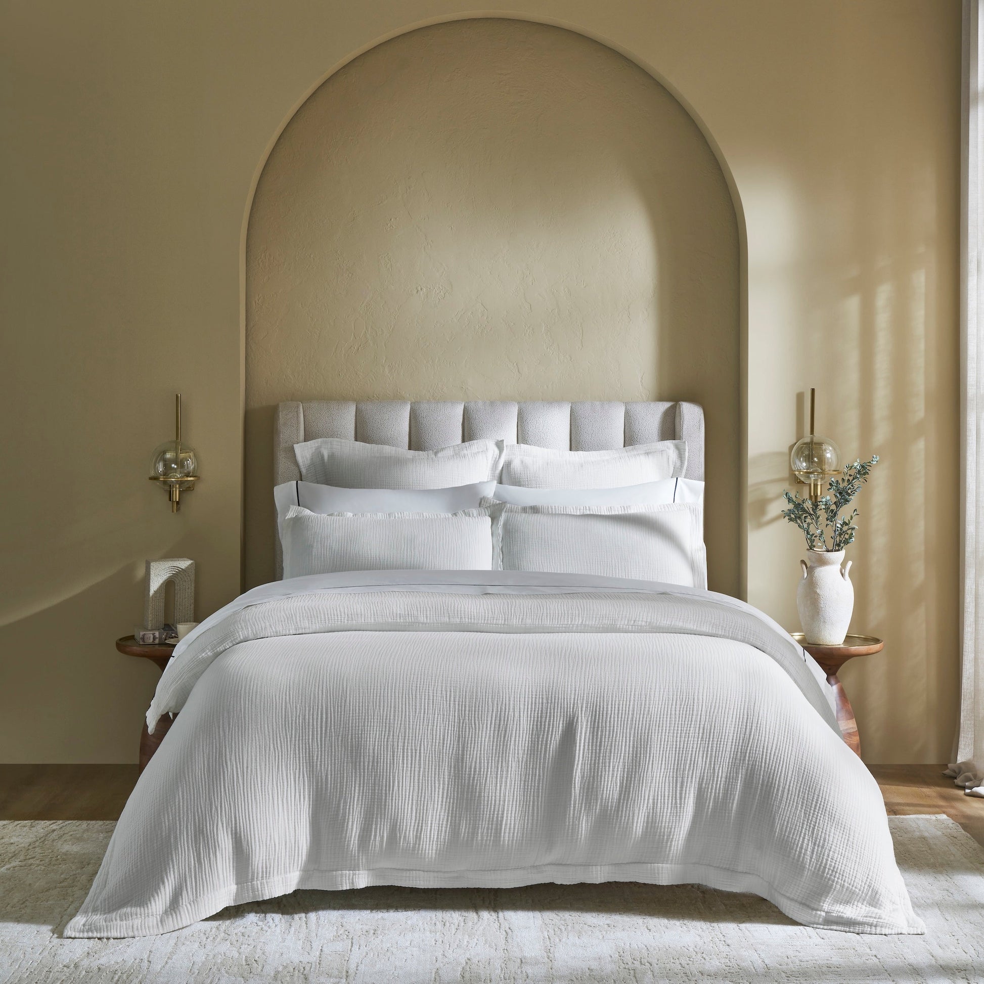 DT-048-10692_1|Pristine white textured duvet cover and matching pillow shams adorning a modern bed, creating a clean, inviting bedroom aesthetic.
