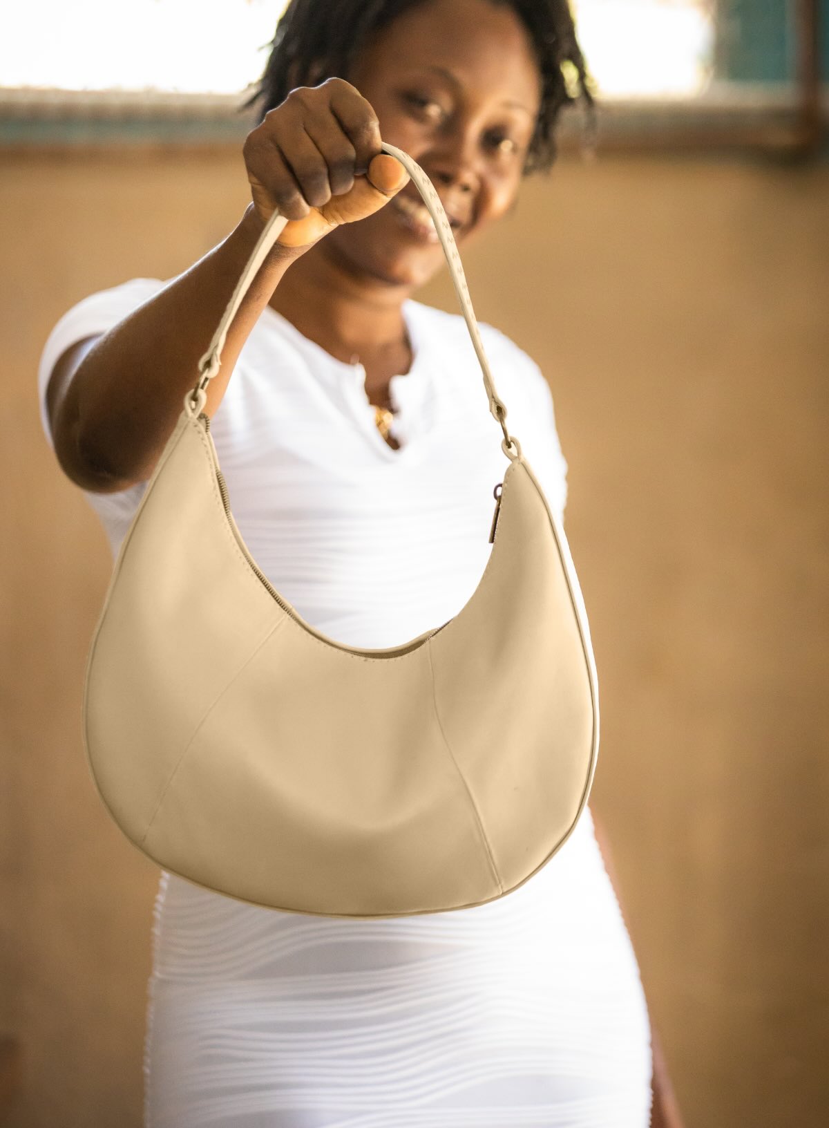 baguette bag from womens handbags in bone color showcasing side view.