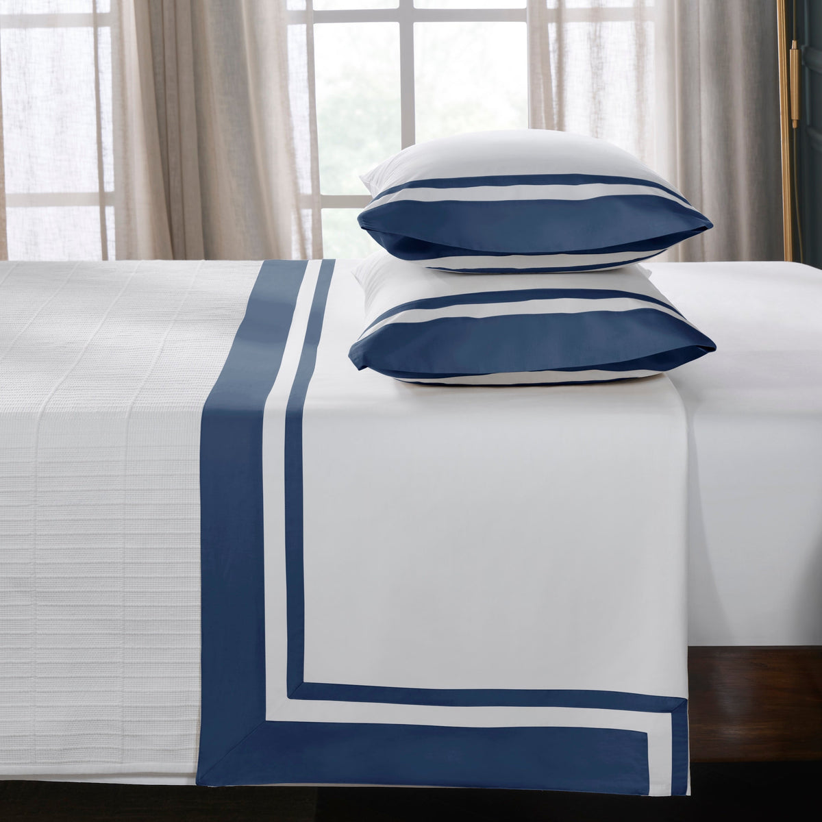 QFL-548-6080_3|Plush white 100% cotton sheets with a sophisticated navy blue stripe border, creating an inviting and cozy bed.