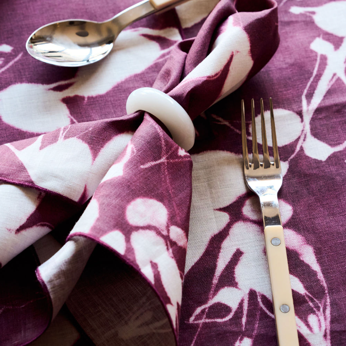 Pearl White napkin rings styled on folded linen napkins on elegant table setting - Goldie Home