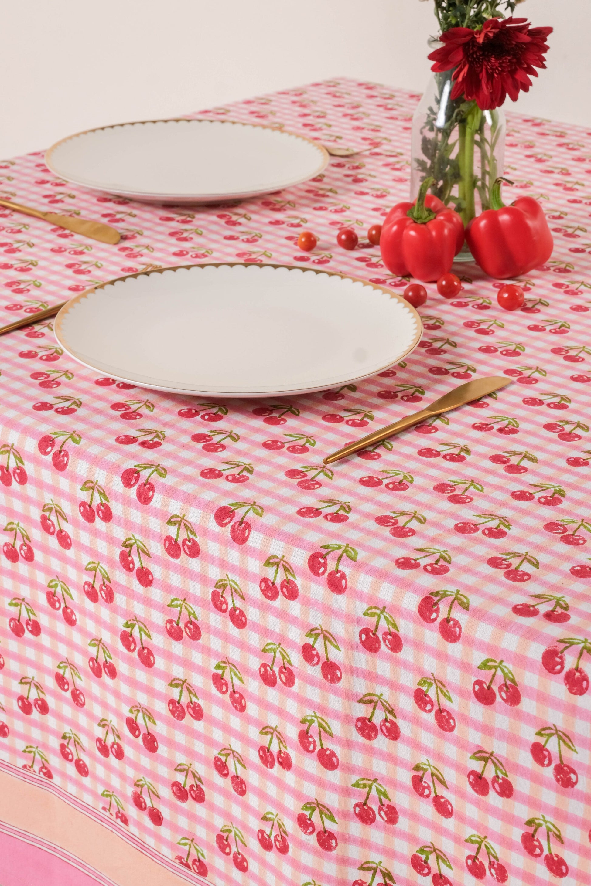 Inner Child cherry blockprint red gingham tablecloth with white plates and utensils