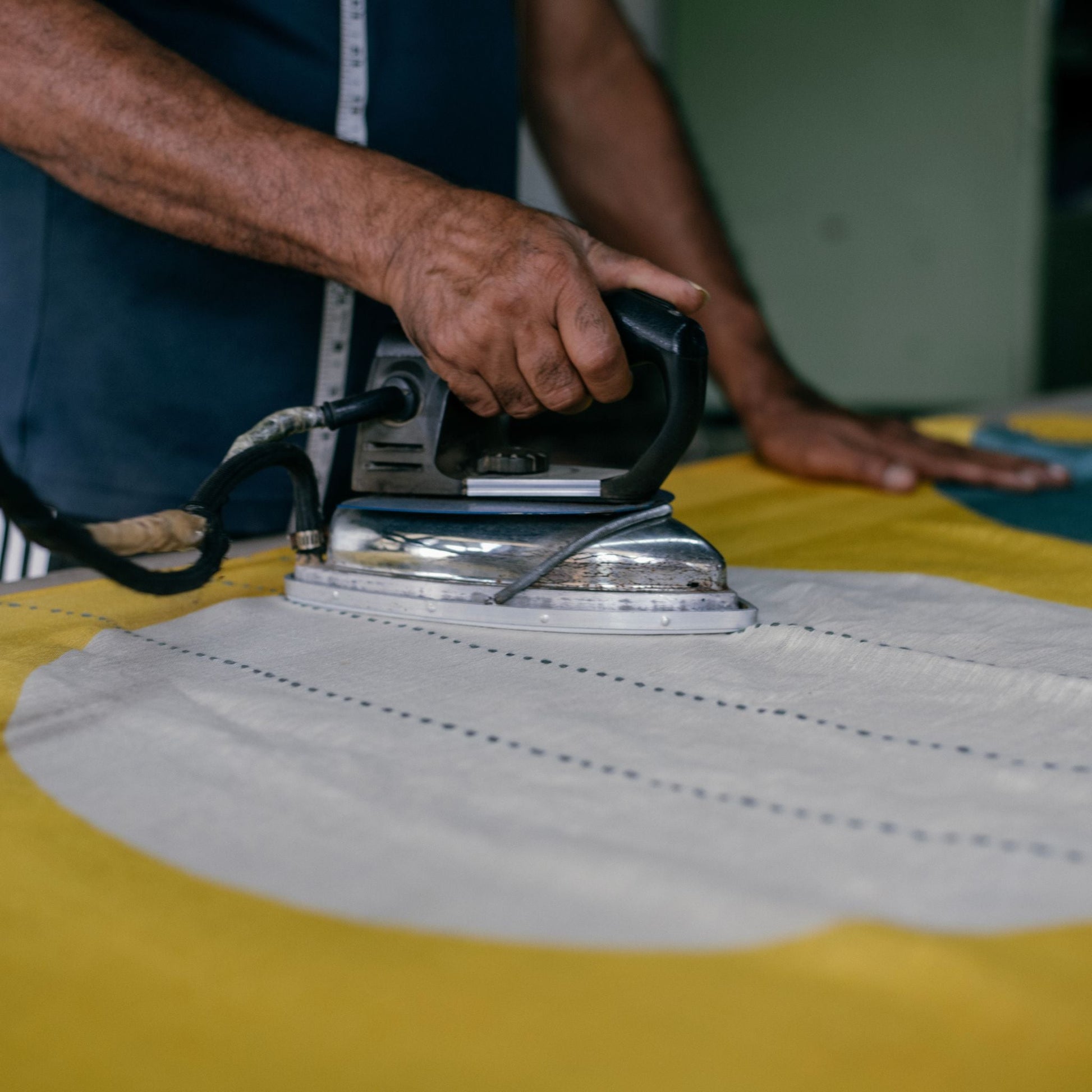 Cirq Sun Yellow Green Circle Pattern Hand Embroidered  Linen Silk Handloom Scarf being ironed with a vintage iron.