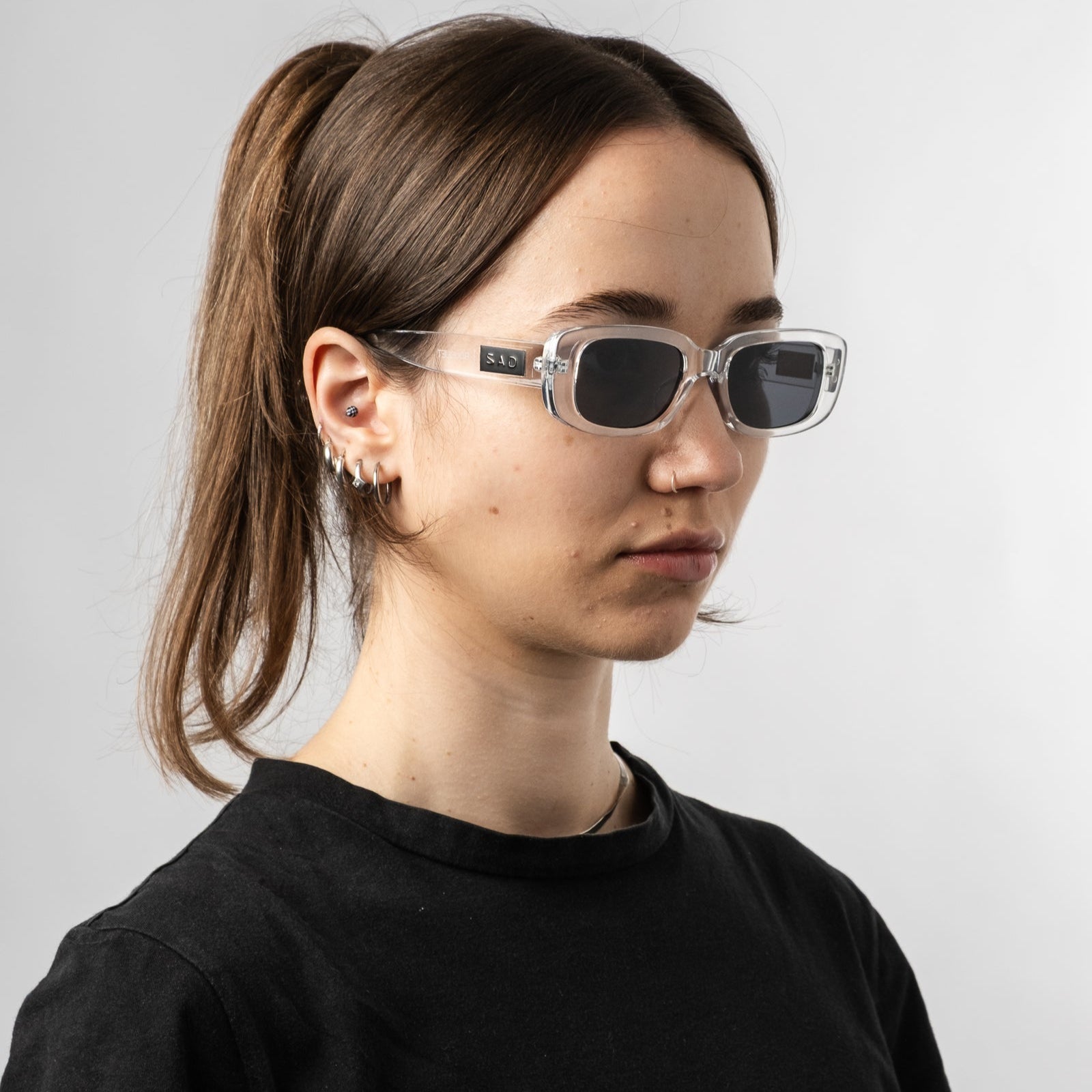 Female wearing Sad Eyewear Bouquet rectangle sunglasses clear frames with uv protection lenses