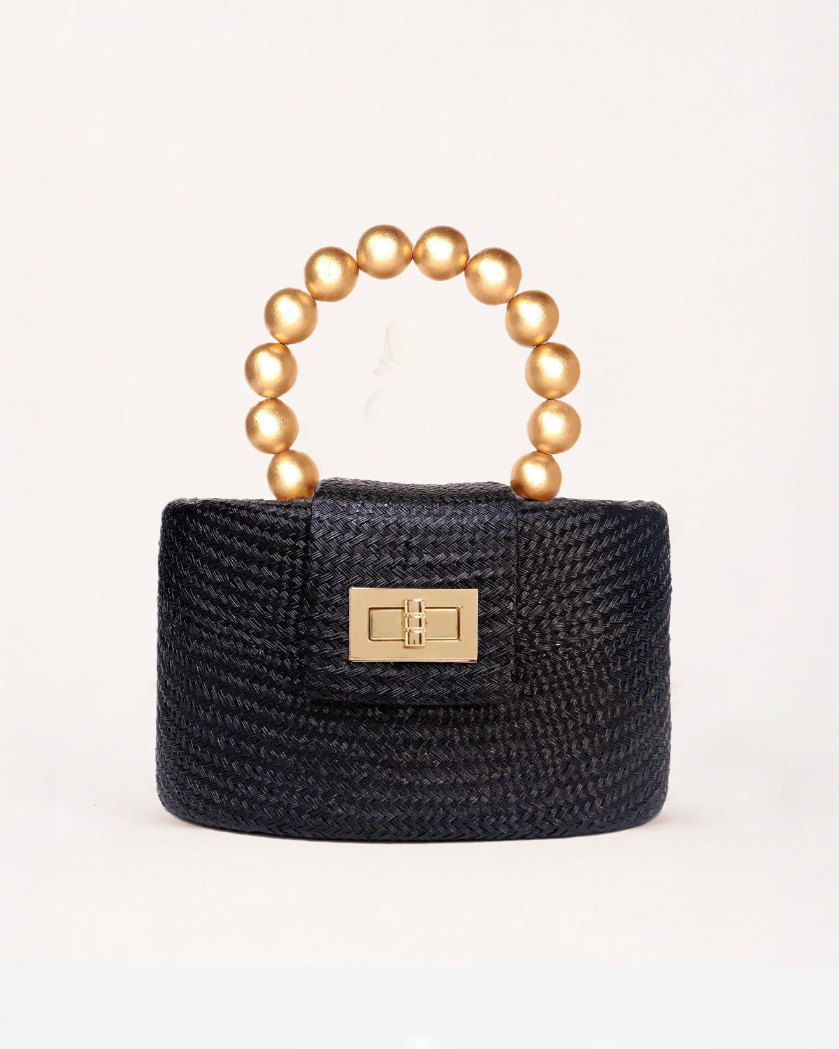 The Olivia black and gold woven straw top-handle bag with gold beaded handle, front view