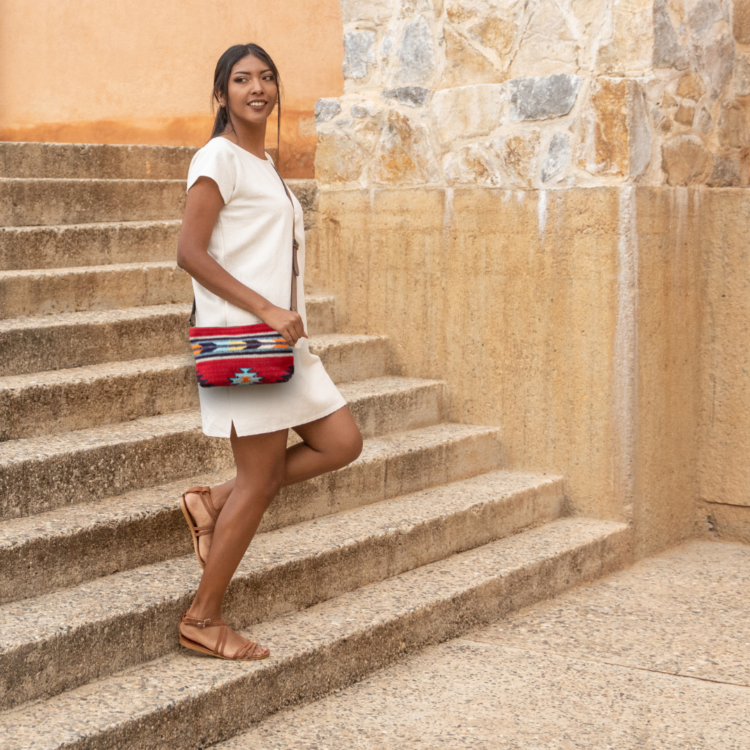 Handwoven convertible clutch with Zapotec pattern in bold colors; can be used as a pouch, wristlet, or crossbody with included leather straps and internal pocket.