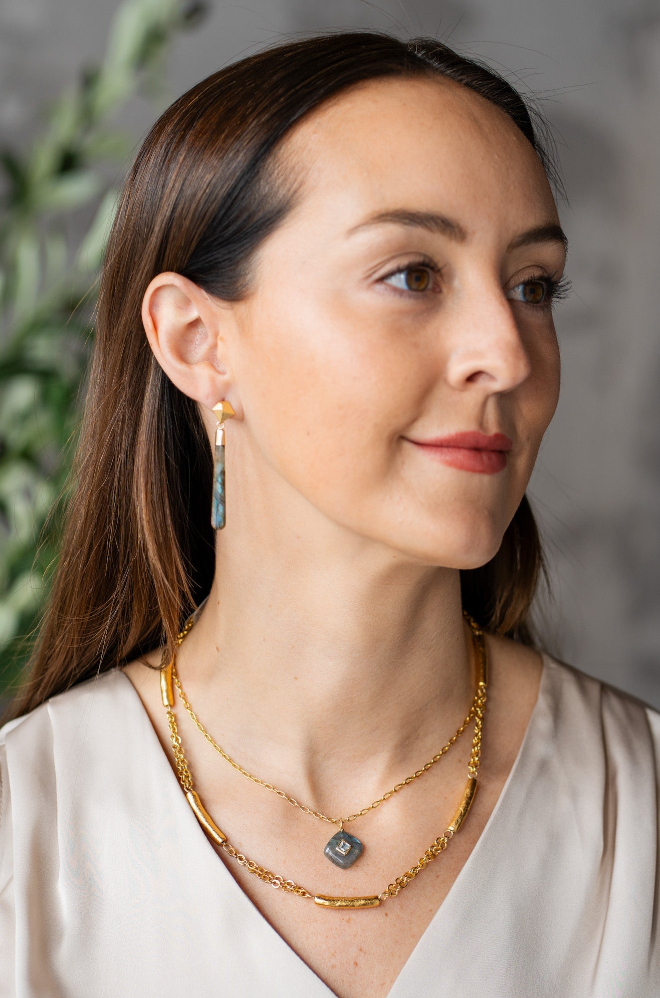 Labradorite pendant necklace with square white topaz inlay on a gold-plated chain.