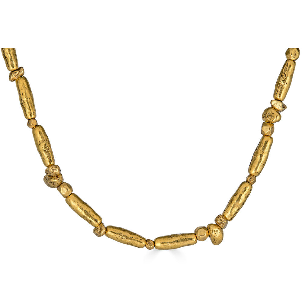 Gold necklace with organic, elongated and irregular bead shapes spaced along a double strand chain, finished with an adjustable clasp.