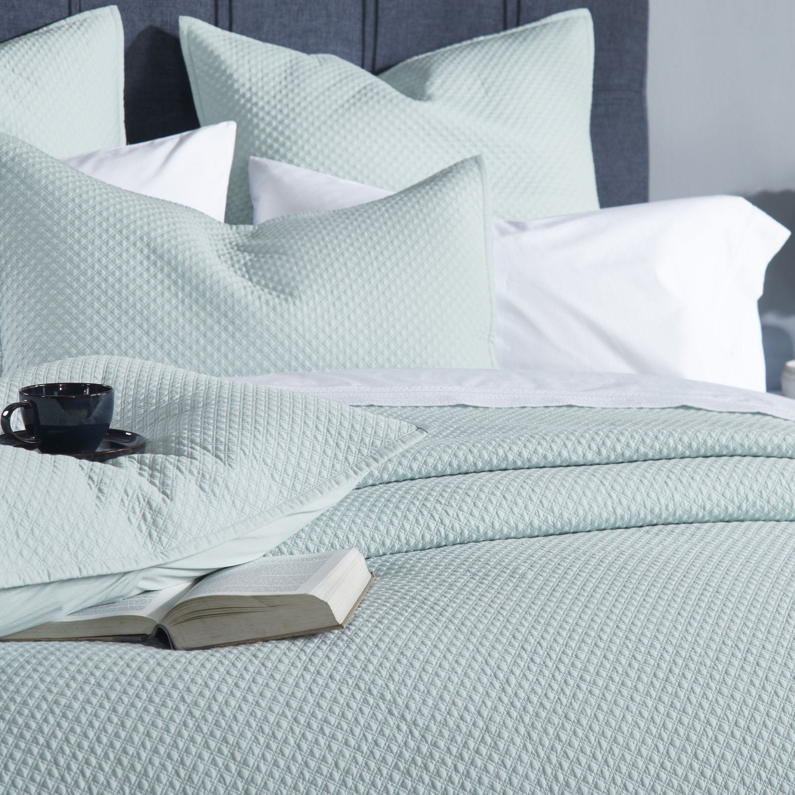 CL-252-9496_4|Intimate close-up of a refreshing mint green quilted coverlet, emphasizing its soft, intricate texture for luxurious bedding.