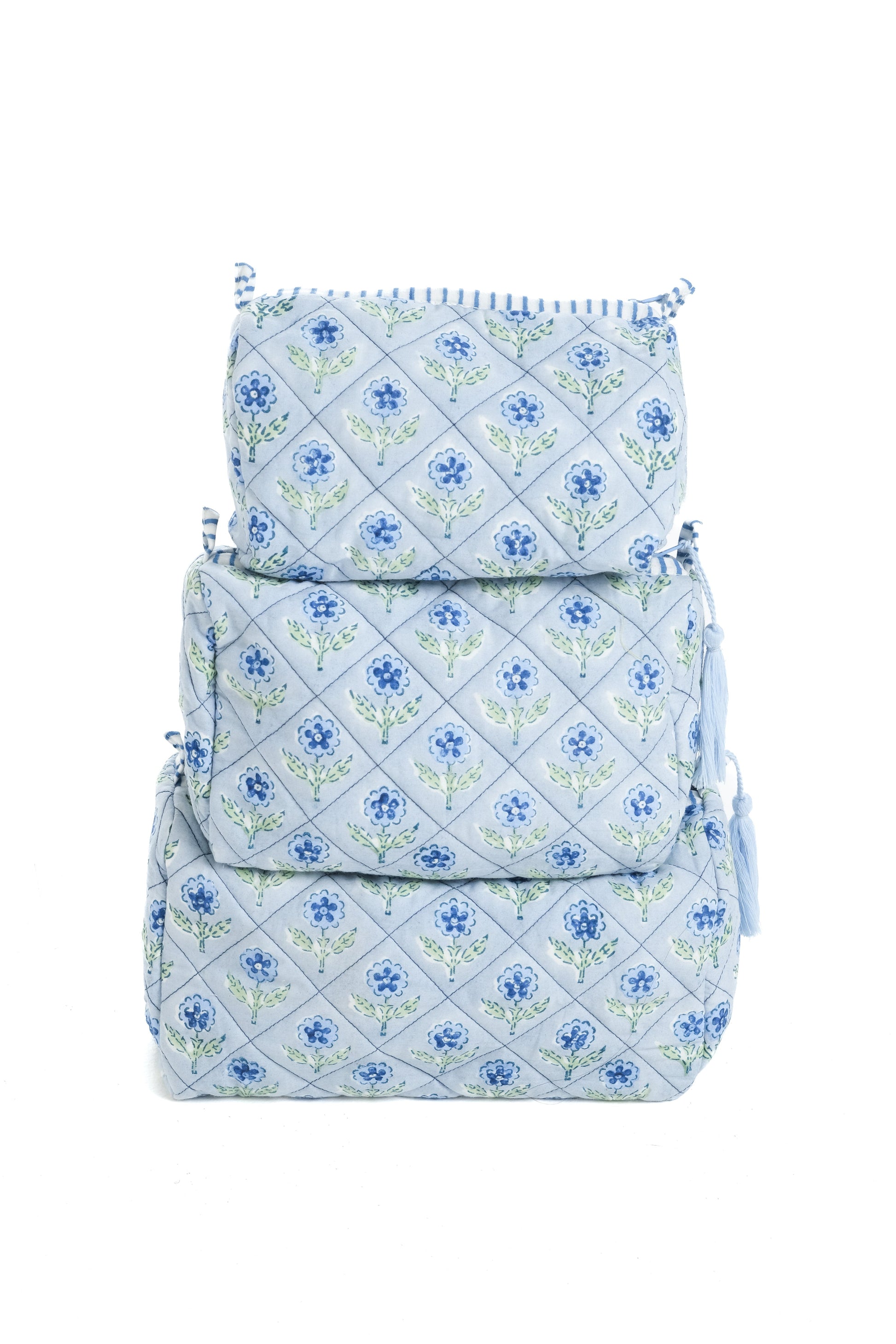 Stacked blue blockprint makeup bags with floral pattern