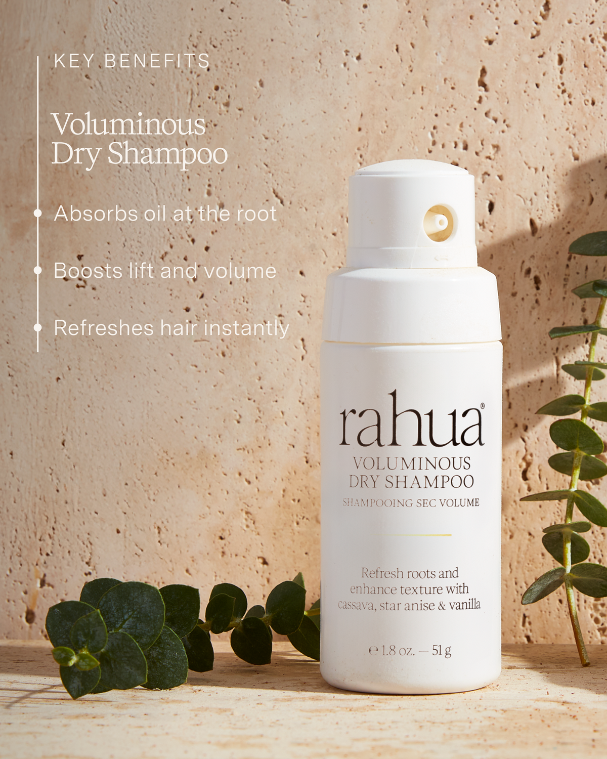 Rahua voluminous dry shampoo bottle with key benefits listed on a textured beige background.