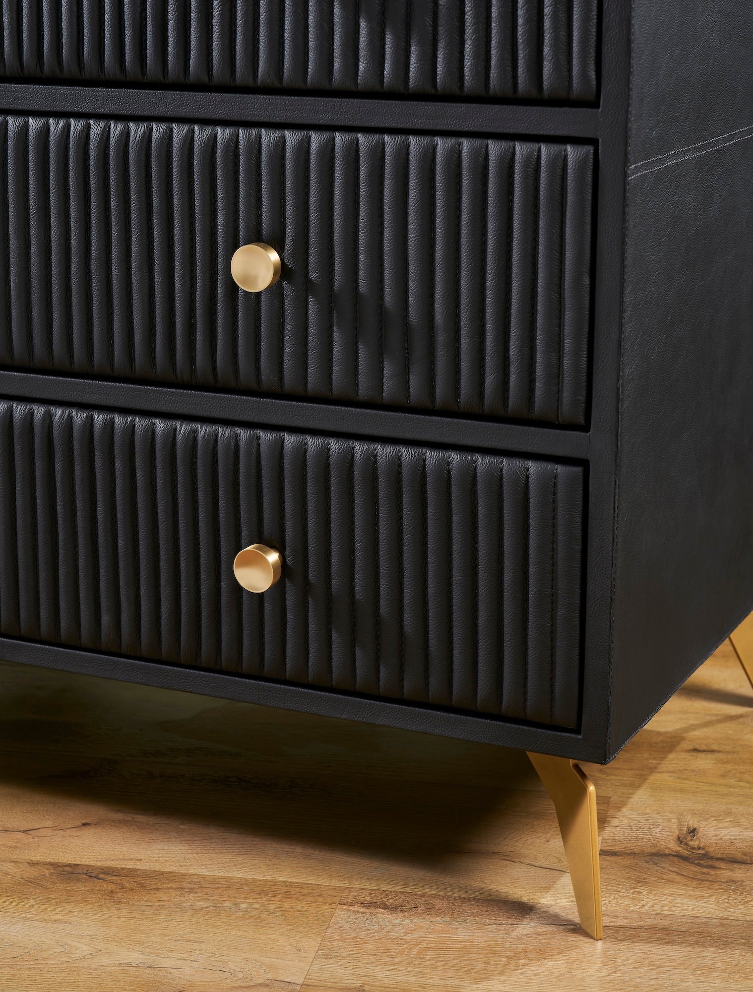 FN-5217-482036_5|Modern black leather chest of drawers with elegant fluted design, sleek gold hardware, and sturdy golden legs, perfect for luxury bedroom furniture.