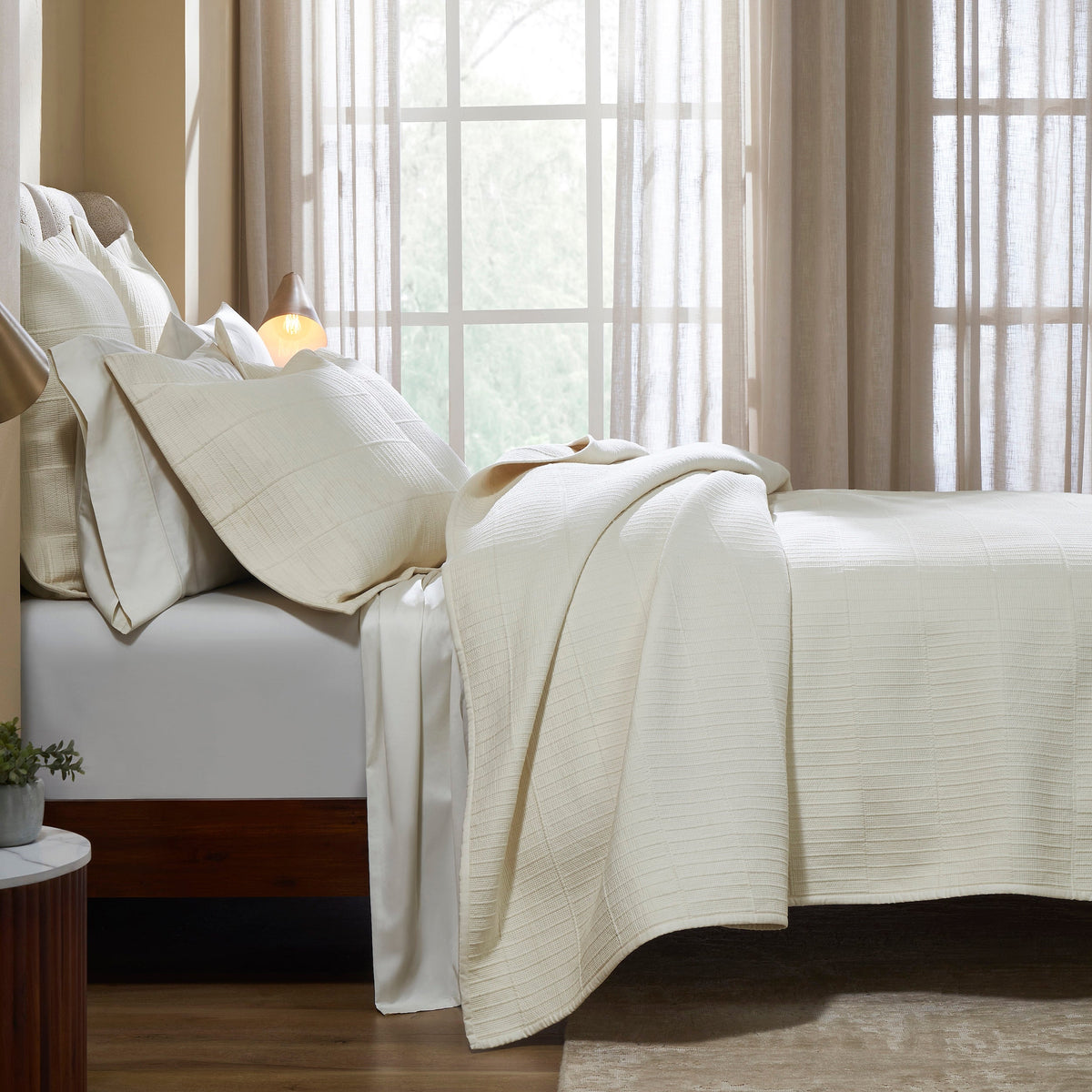 CL-271-9496_3|Luxurious cream textured coverlet with subtle grid pattern, draped elegantly on a bed, offering sophisticated comfort for modern bedrooms.