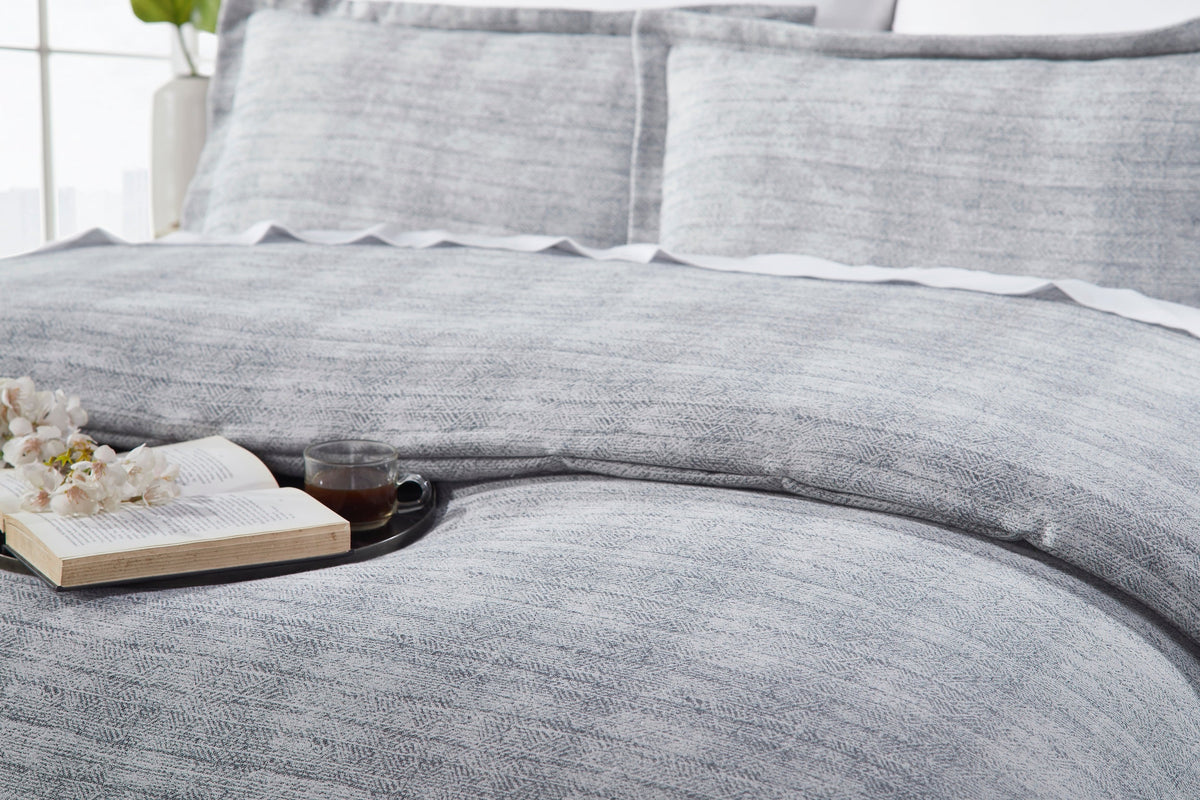 DT-035-9092_4|Relaxed gray textured duvet cover draped elegantly on a bed, suggesting comfort and serene modern bedroom ambiance.