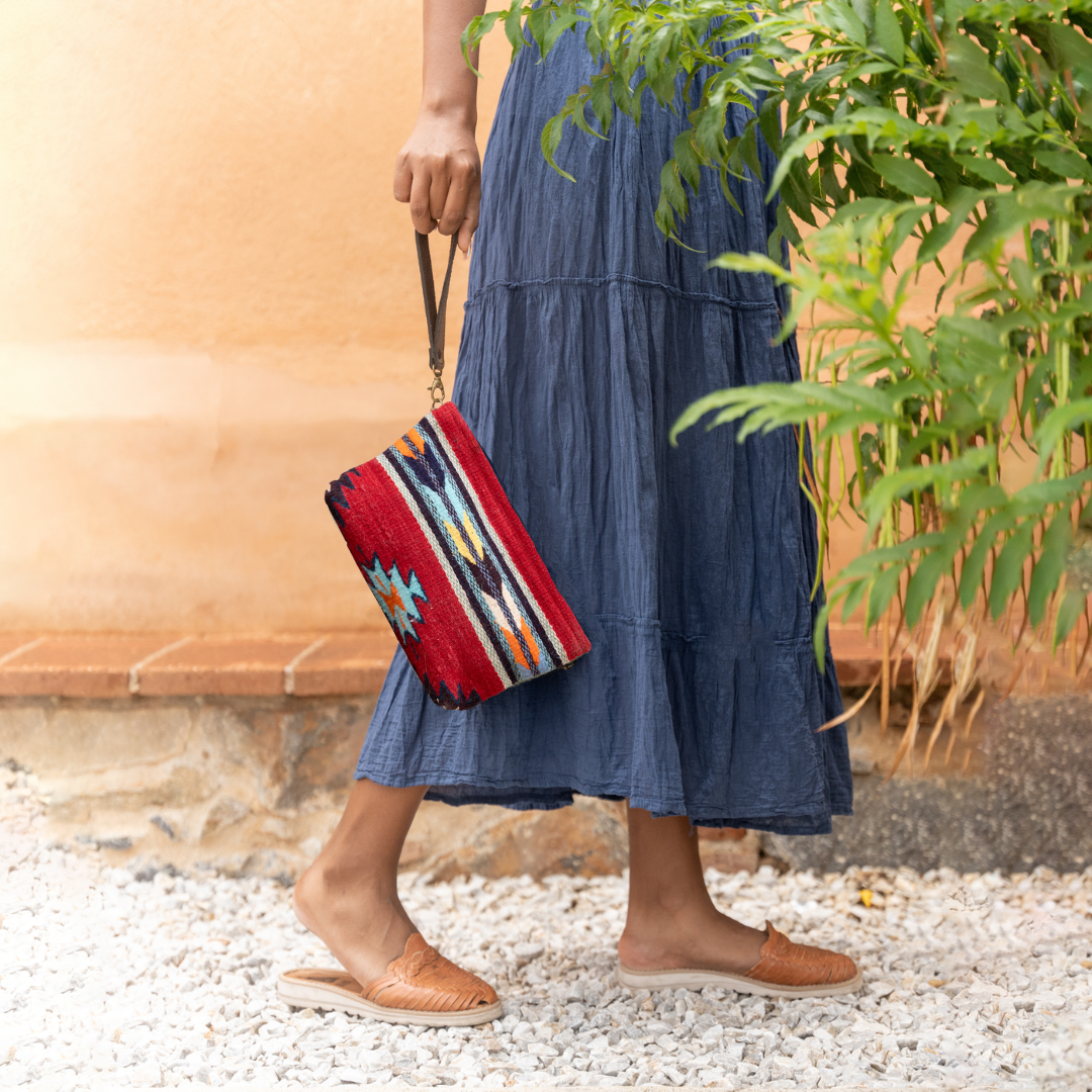 Handwoven convertible clutch with Zapotec pattern in bold colors; can be used as a pouch, wristlet, or crossbody with included leather straps and internal pocket.