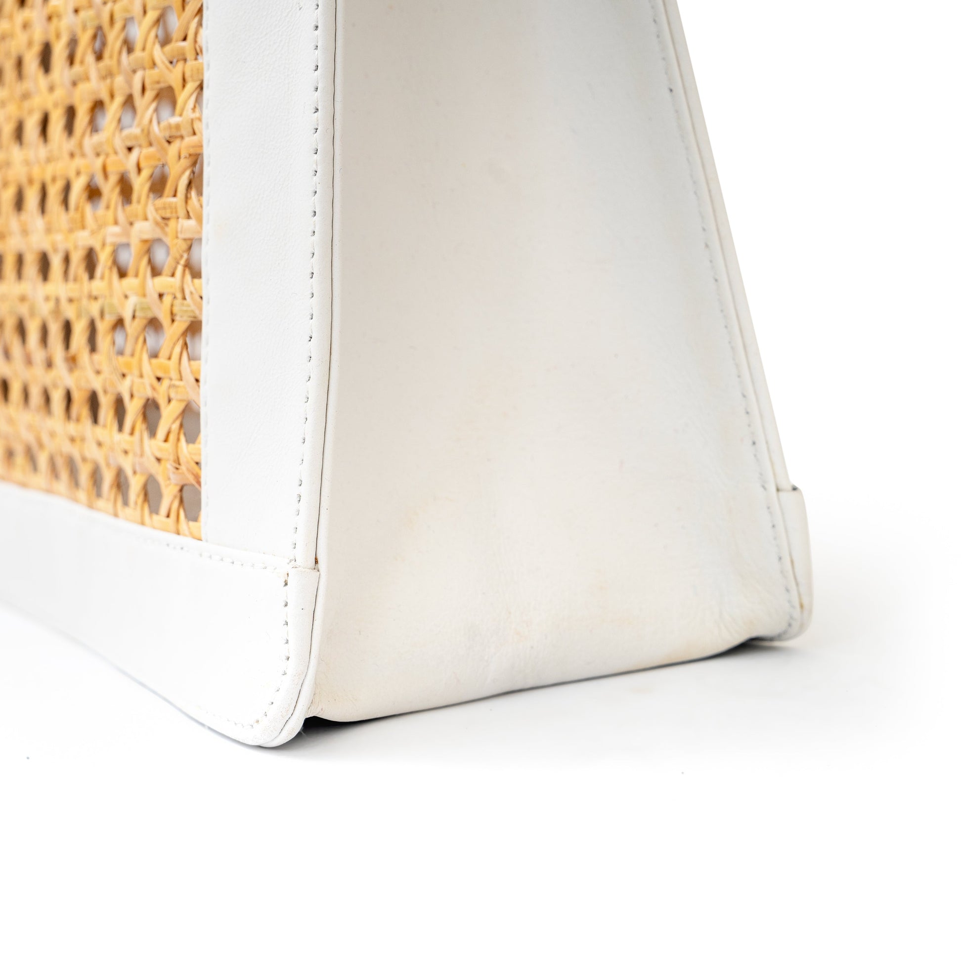 detail view white leather and cane webbing rattan top handle tote handbag