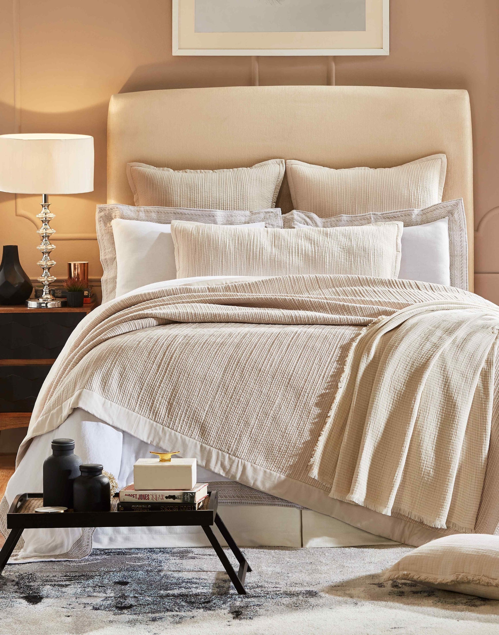 CL-161-9496-LOT1_1|Natural beige textured coverlet elegantly draped on a bed, creating a warm, inviting layer for a sophisticated bedroom setting.