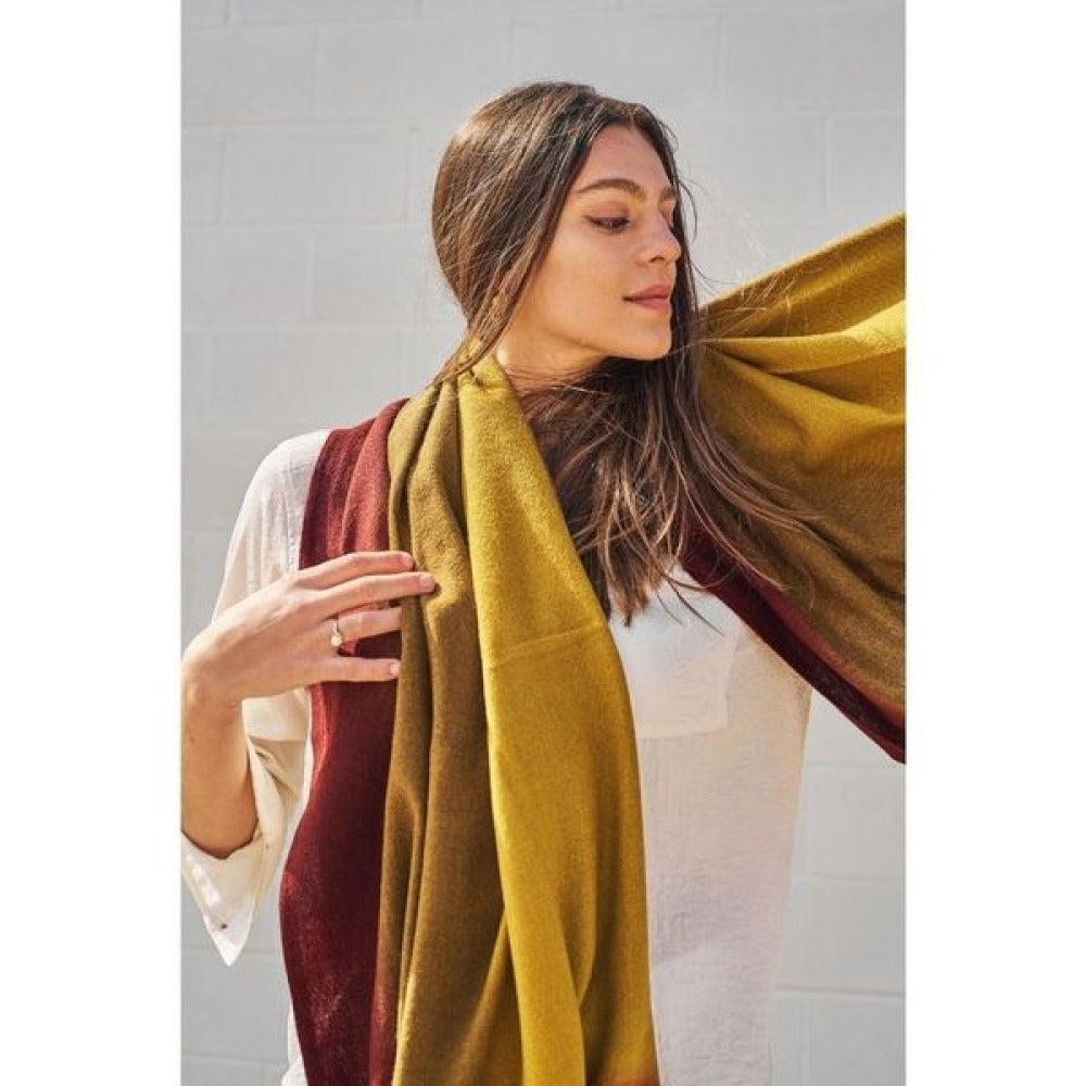 Marigold Merino Ombre Handloom Throw / Blanket Scarf draped elegantly by a model, showcasing its warm color gradience.