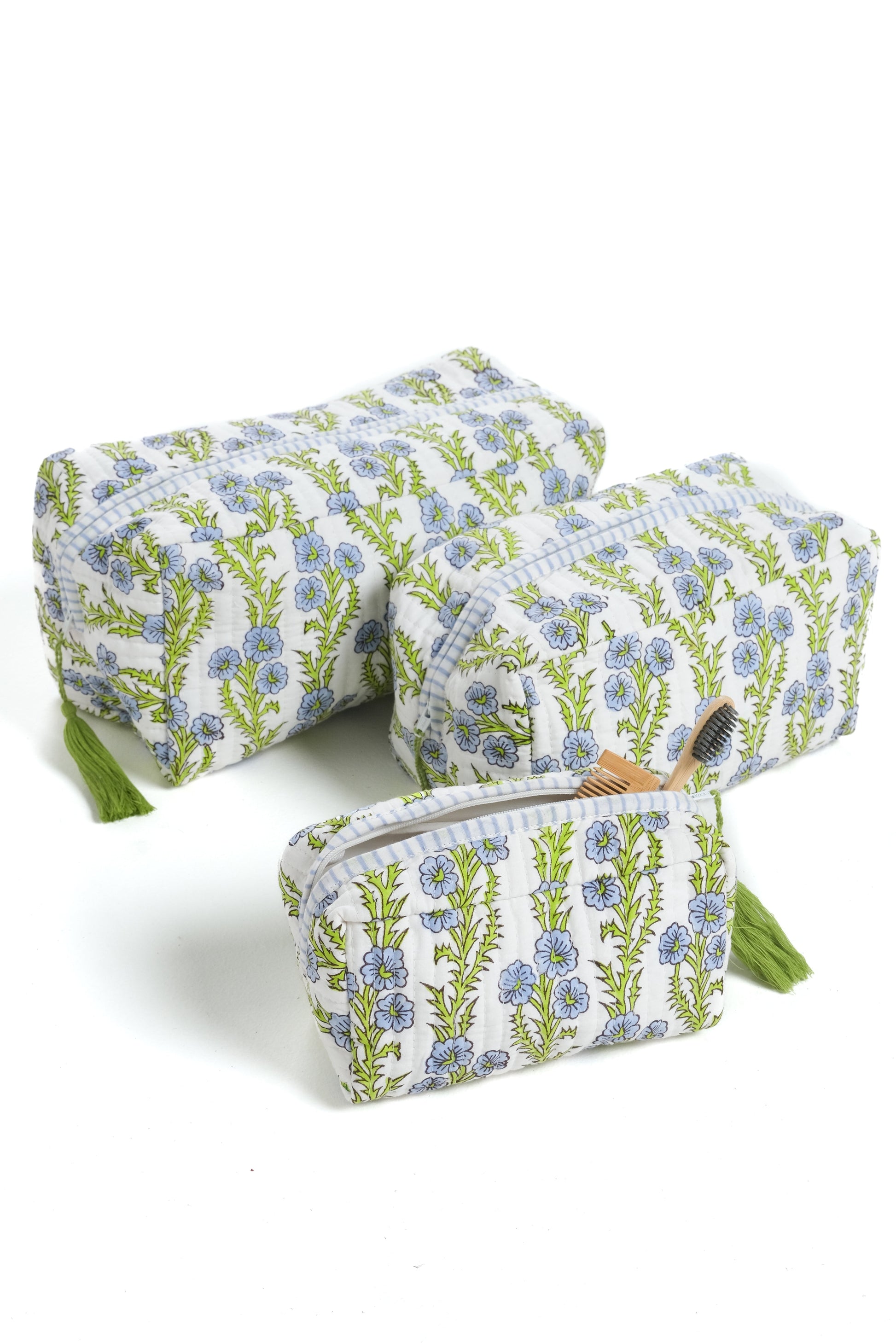 Three blue forget-me-not blockprint makeup bags with green tassels