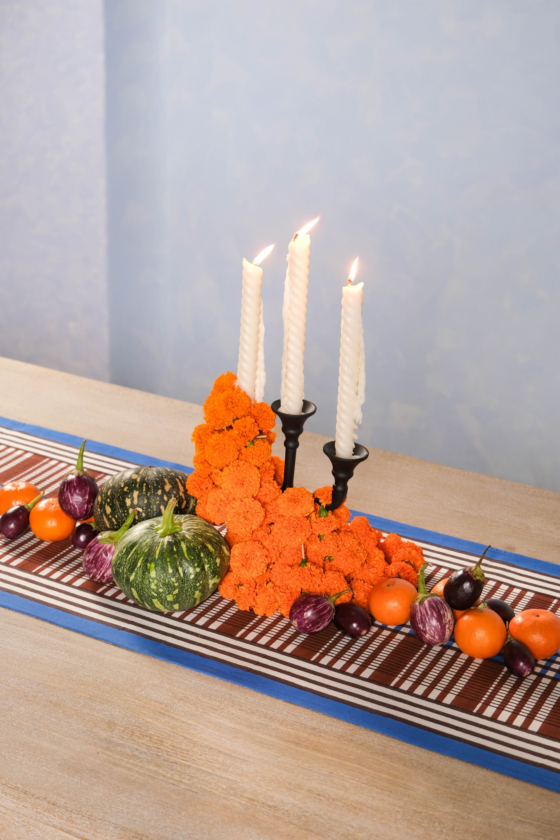 Brown and blue Shetland plaid blockprint taberunner with orange floral centerpiece