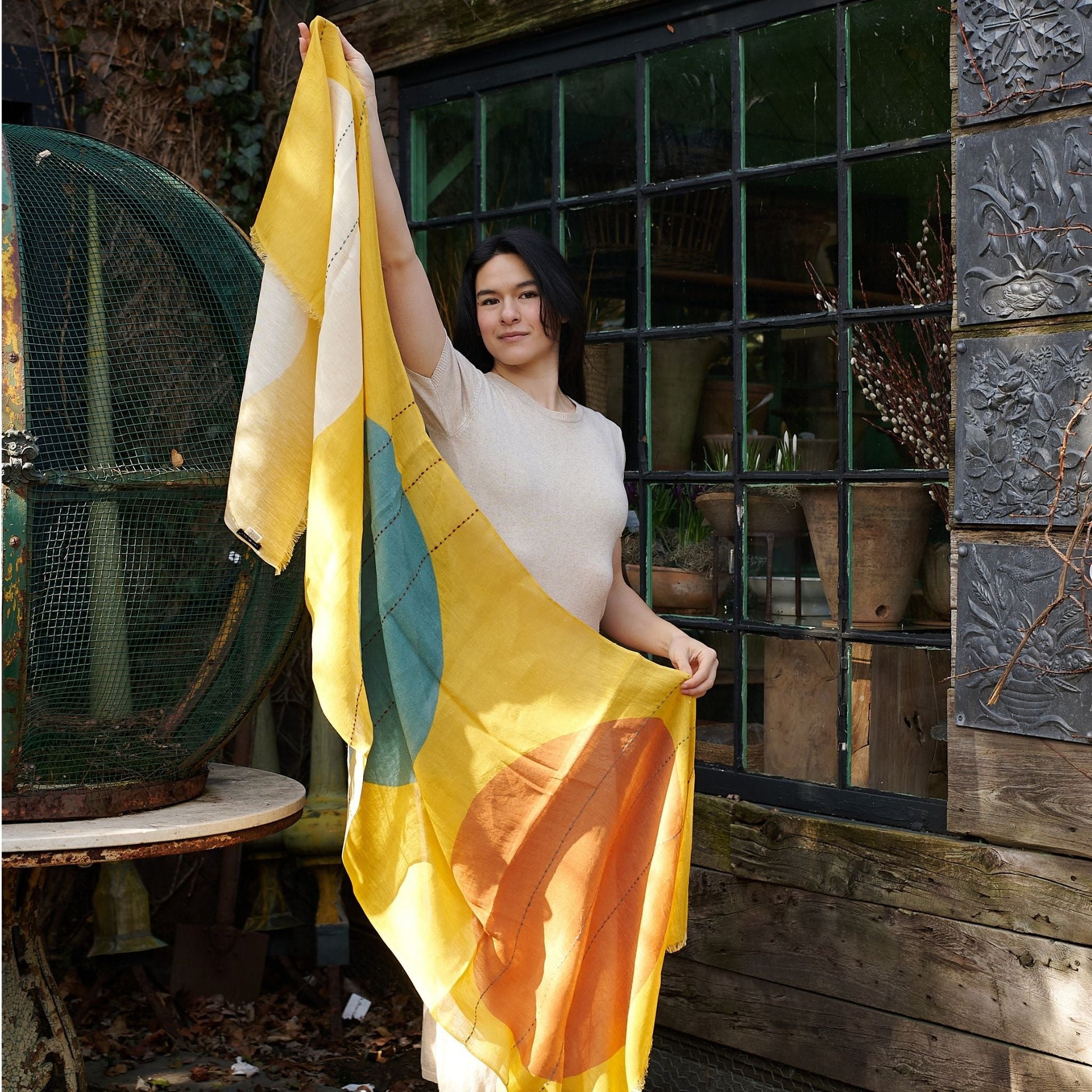 Cirq Sun Yellow Green Circle Pattern Hand Embroidered  Linen Silk Handloom Scarf displayed by a model outdoors.