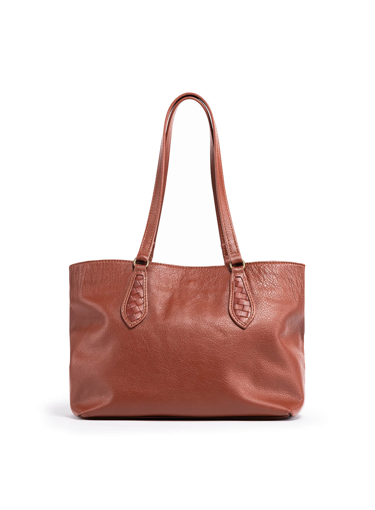 The mid tote in mahogany from the spring collection held by model sitting down.