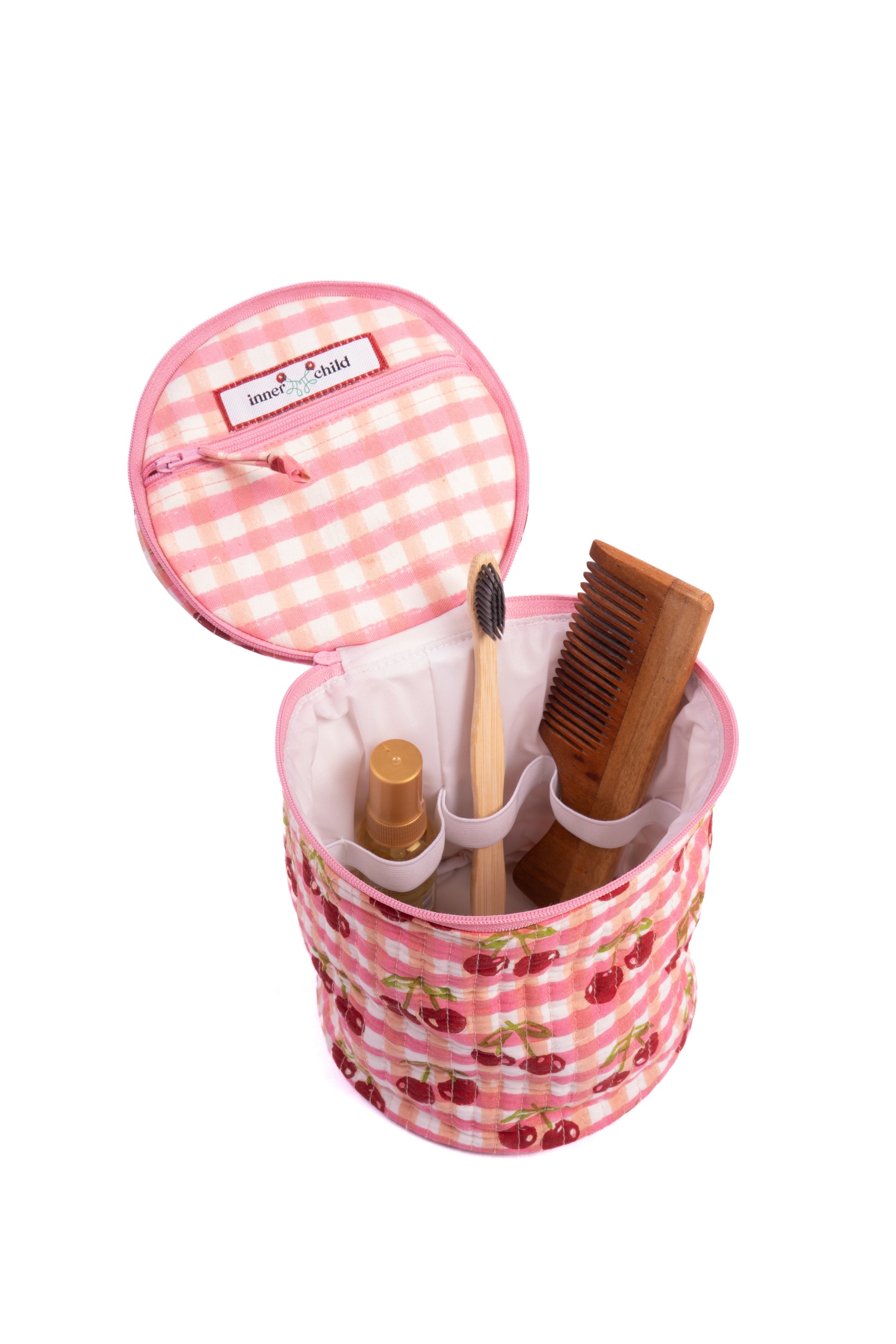 Inner Child cherry gingham makeup bag with toiletries inside