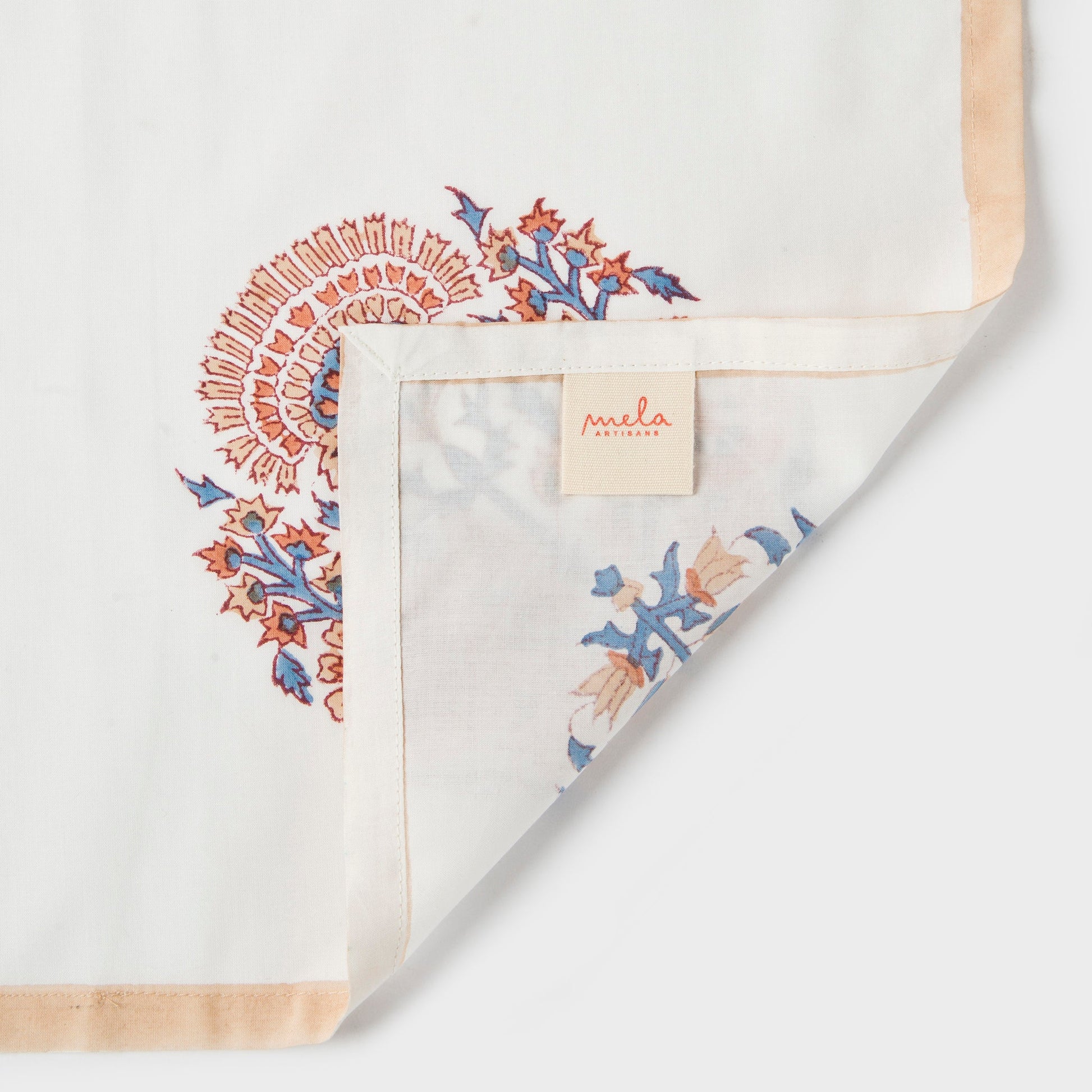Mela Artisans Saffra floral block print napkins in a neatly folded arrangement.