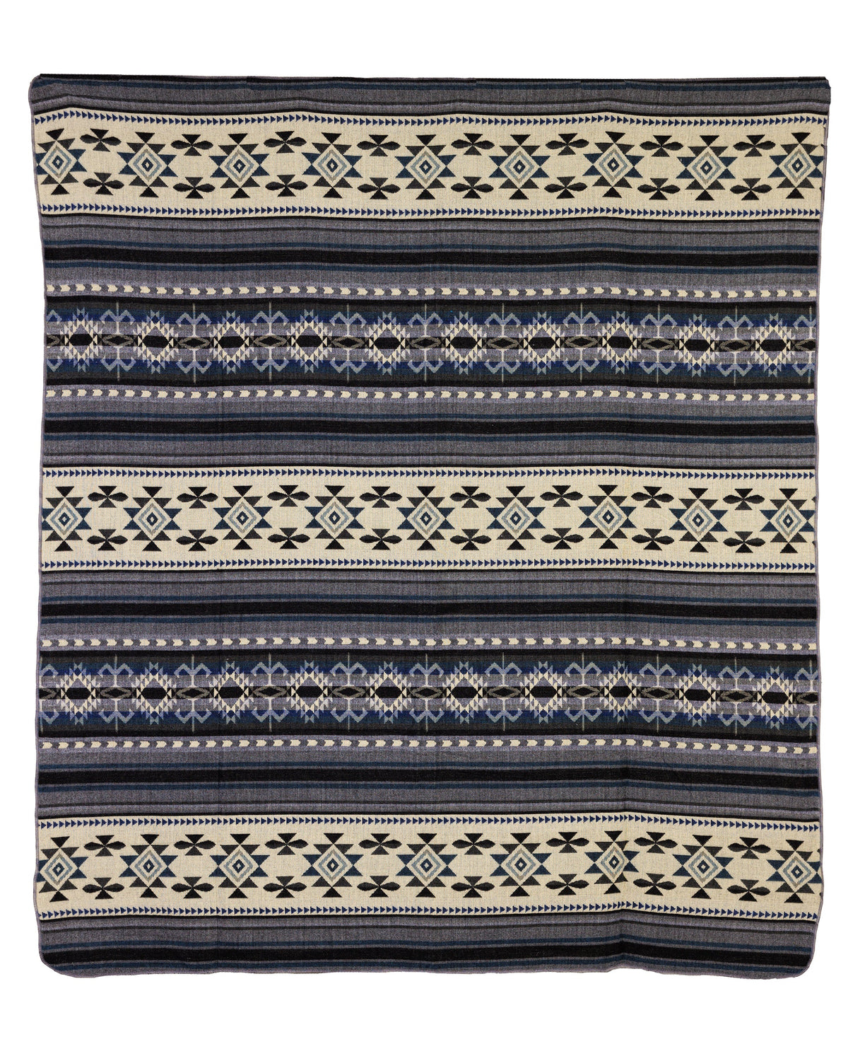 A geometric patterned throw blanket in shades of blue, gray, and cream, with a reversible design showing a light cream side with gray and deep blue accents.