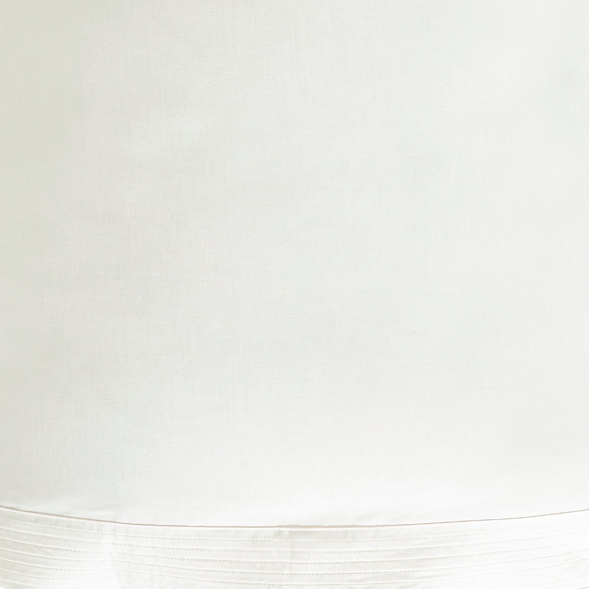KSS-522-7880_6|Close-up of creamy white 100% cotton sheets showcasing elegant vertical pleat detailing on the hem.