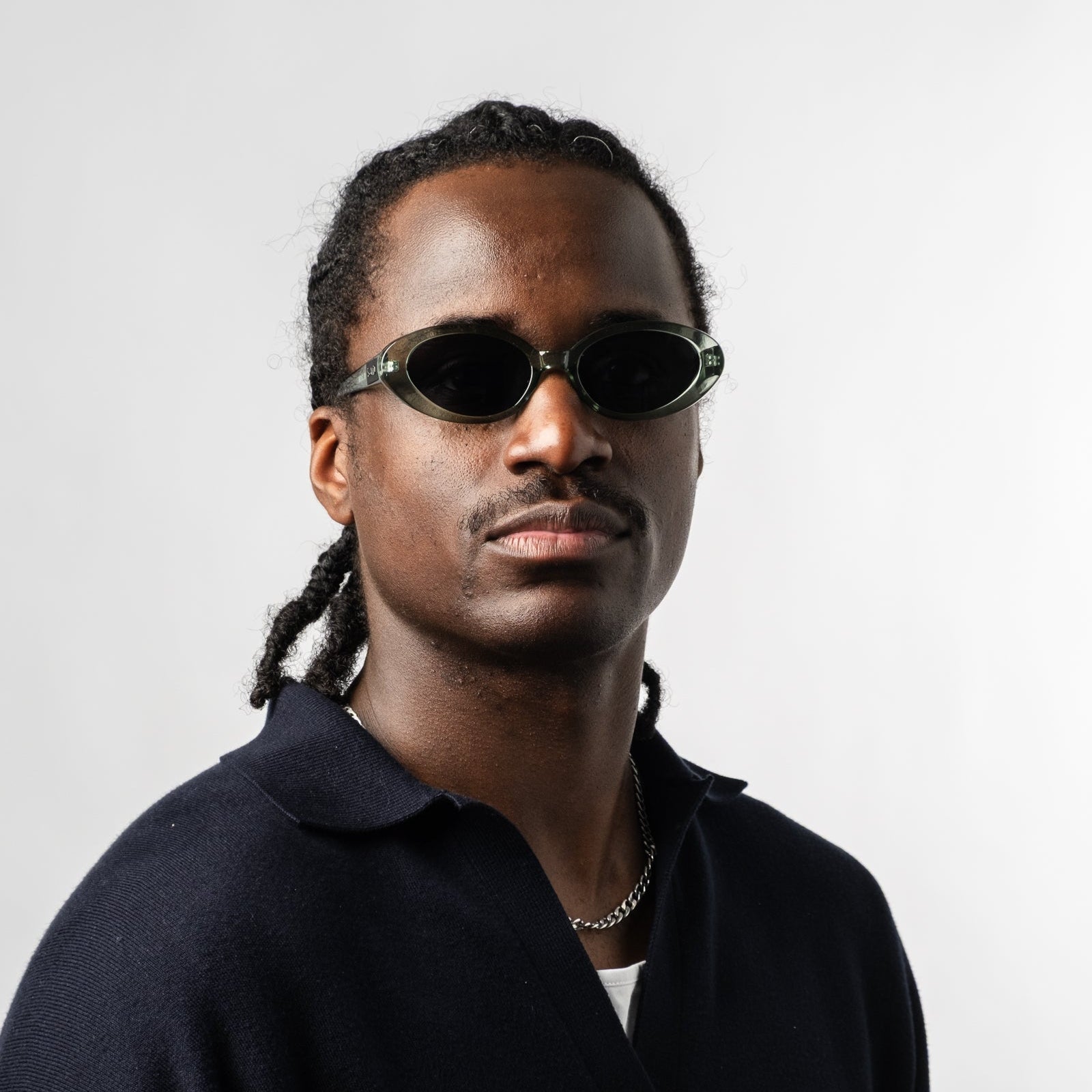 Male wearing Sad Eyewear Bloom oval sunglasses in sea glass green with tinted black lenses