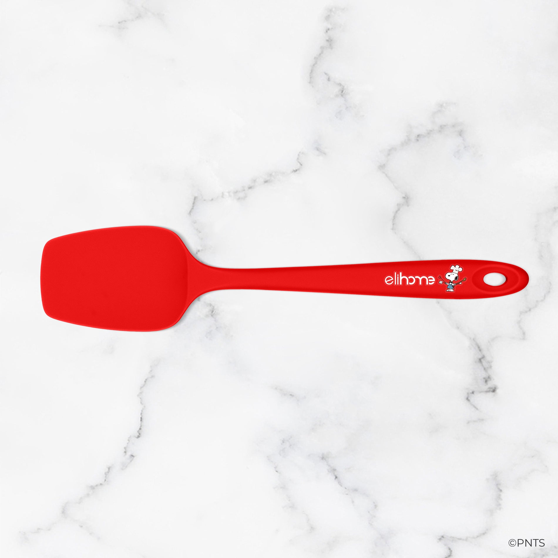 Red spatula with a brand logo on a marble background