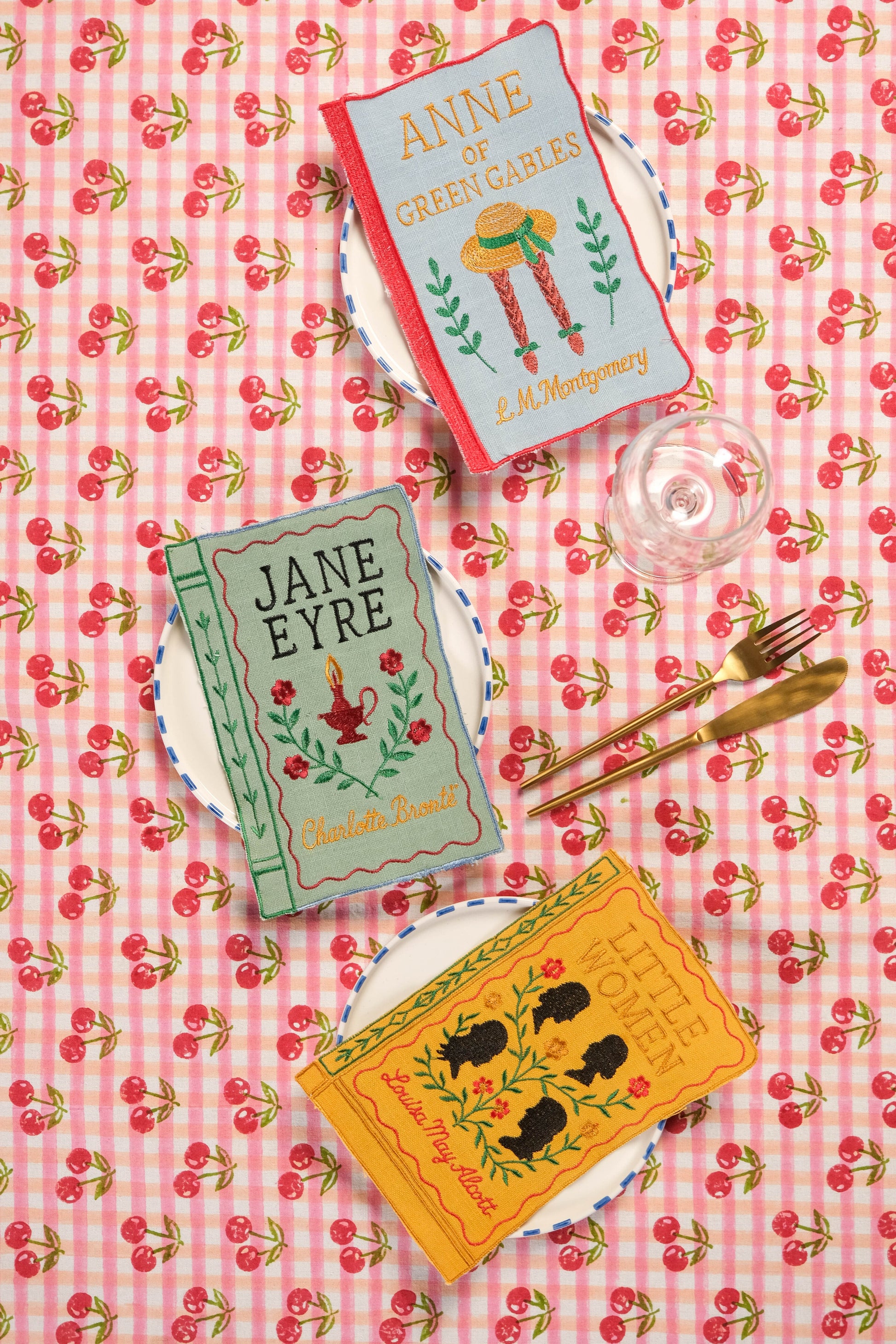 Red gingham cherry blockprint tablecloth with book-themed decor