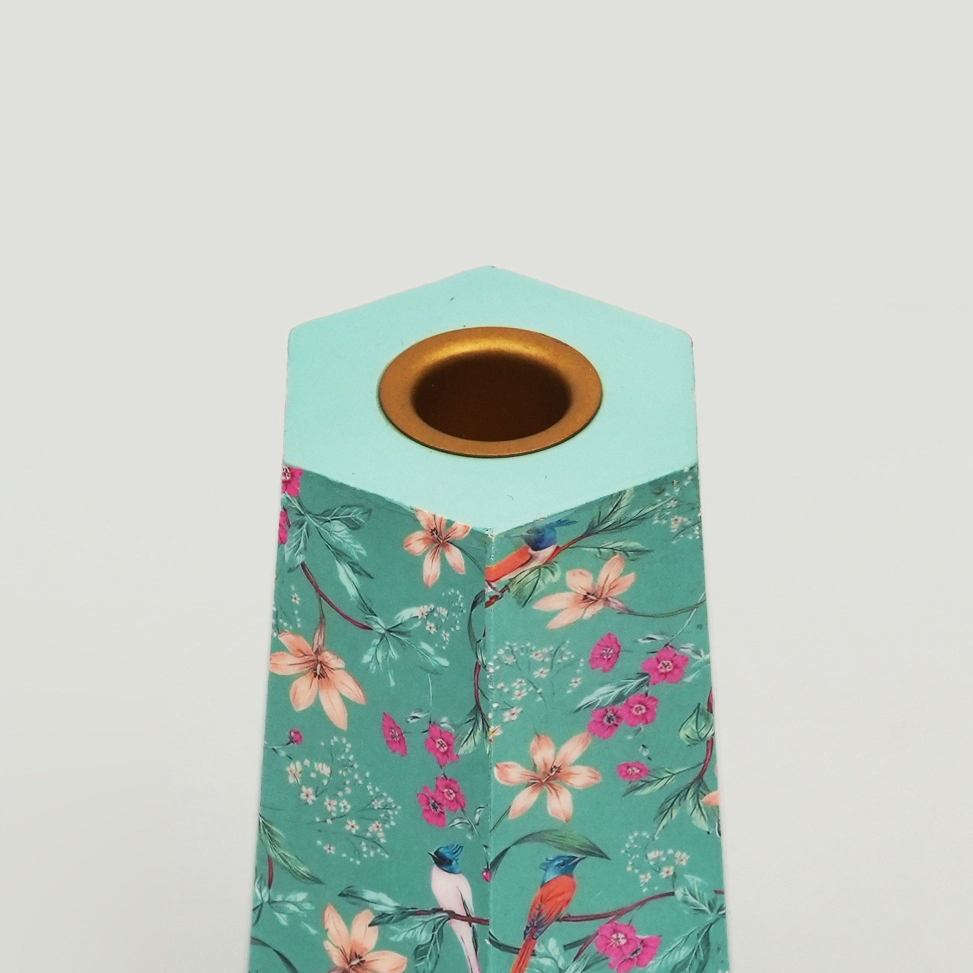 Close-up of intricate pink floral detailing on a glossy aqua enamel hexagonal base.