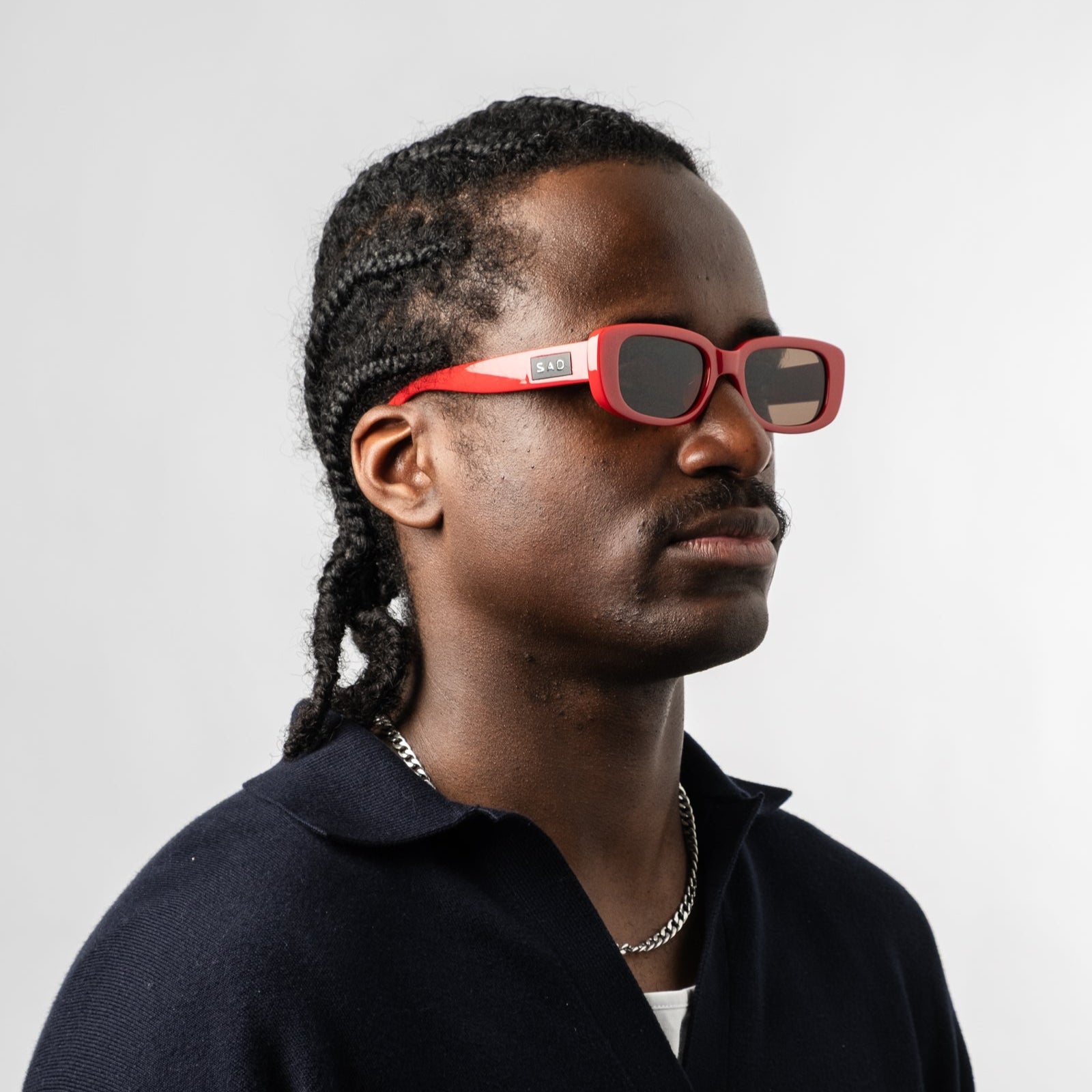 Male wearing Sad Eyewear Bouquet rectangle sunglasses in cherry red with uv protection lenses