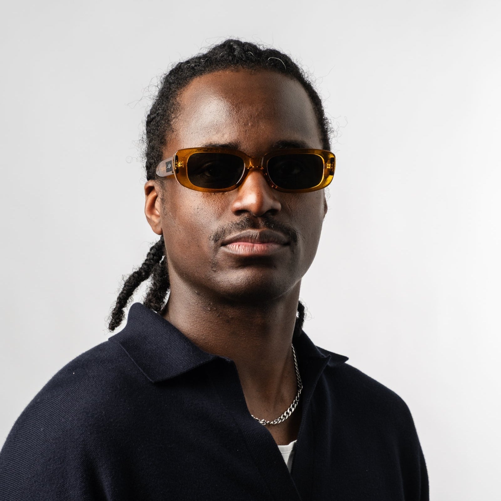 Male wearing Sad Eyewear Bouquet rectangle sunglasses in amber with UV protection lenses