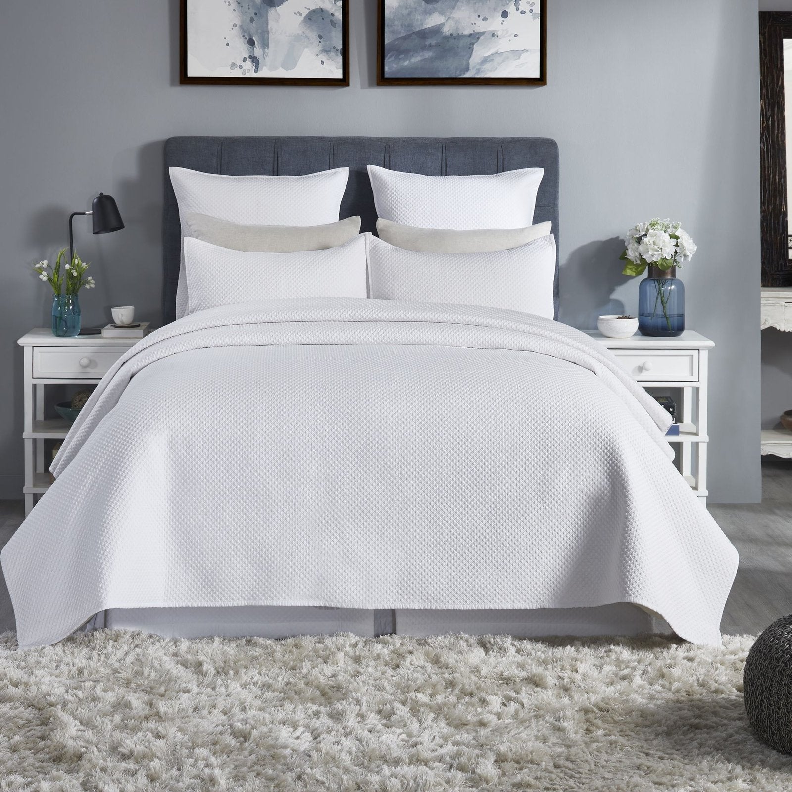 CL-200-11096_1|Pristine white textured coverlet elegantly drapes a bed in a modern, serene bedroom setting. Ideal for stylish decor.