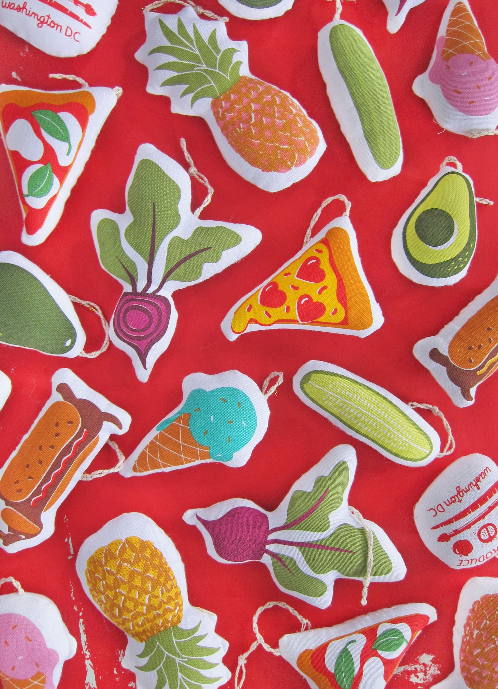 Avocado ornament pictured with an array of other Neighborgoods holiday ornaments