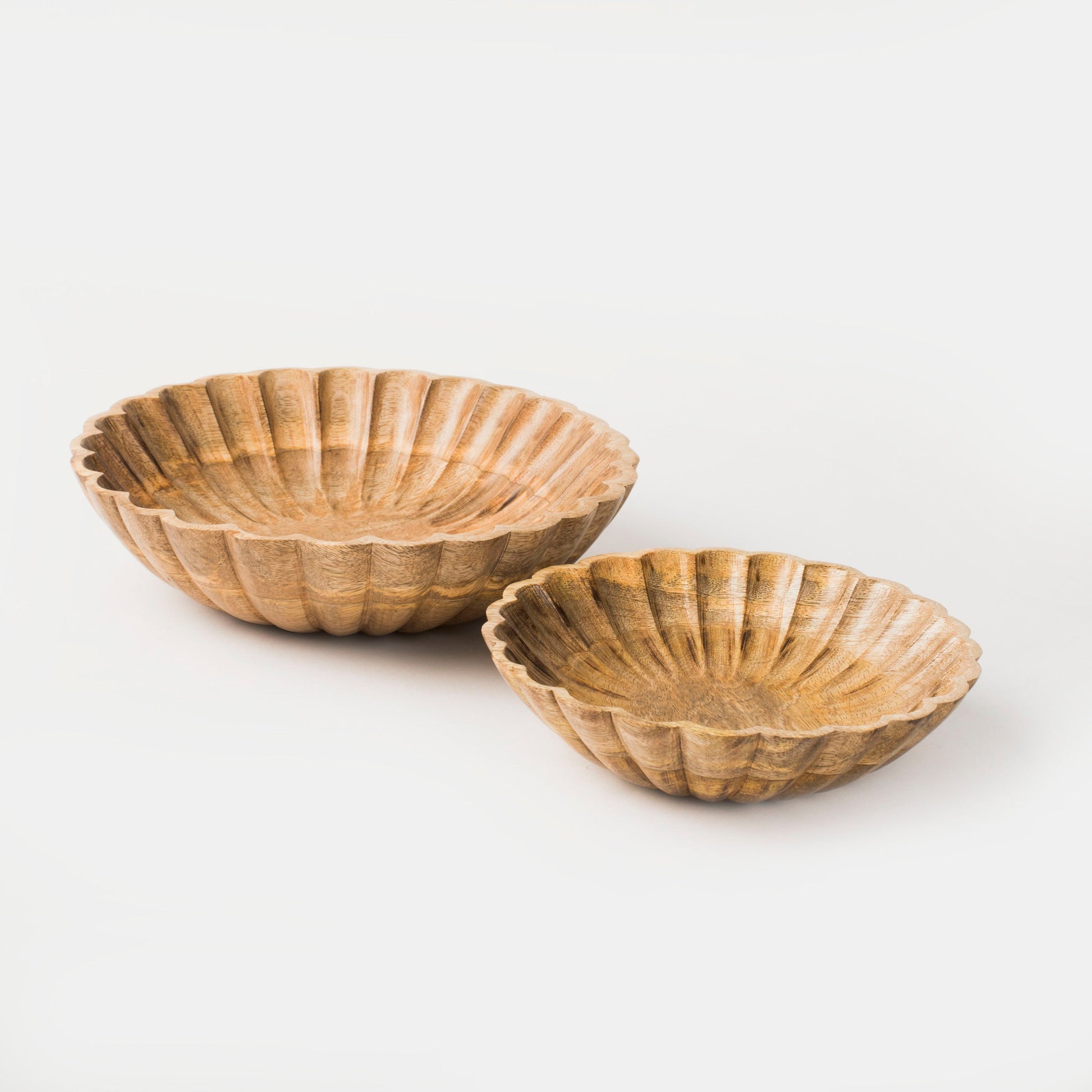 Set of two hand-carved scalloped mango wood bowls nested together