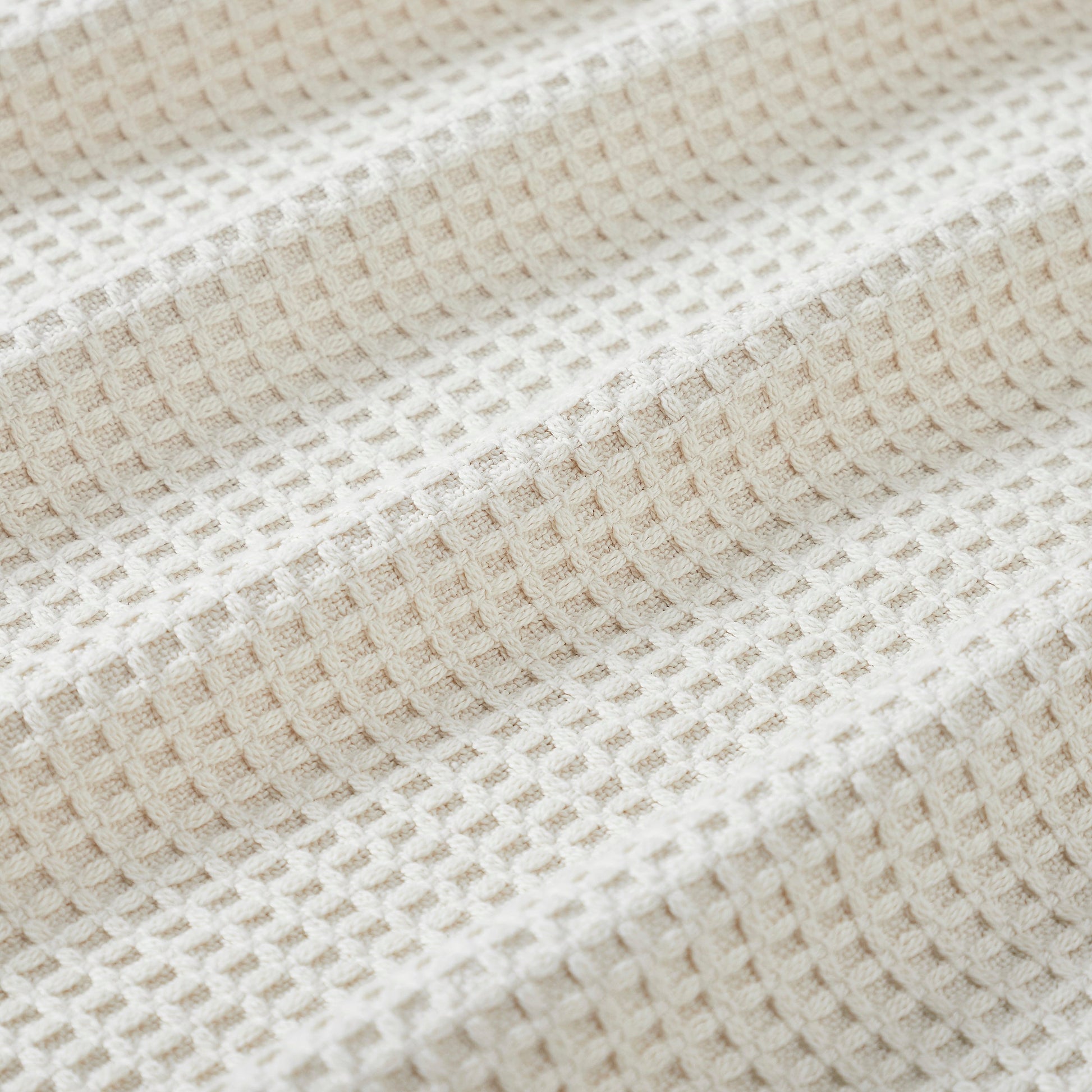 BL-867-11096_4|Close-up of a cozy cream waffle weave blanket texture. Soft, breathable cotton for ultimate comfort and home decor accent.
