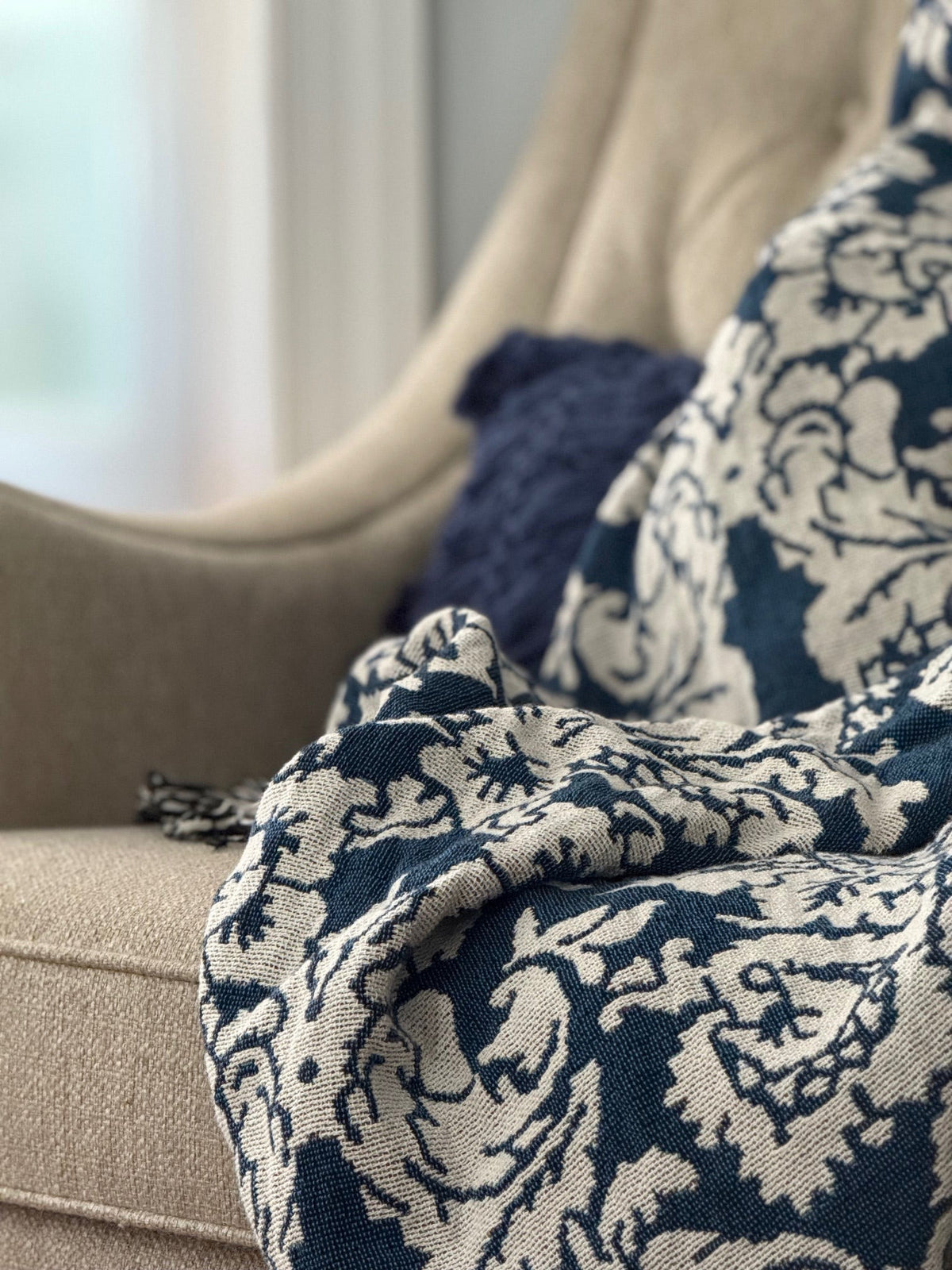 Folded Verona Cerulean floral woven cotton throw blanket shown from the side